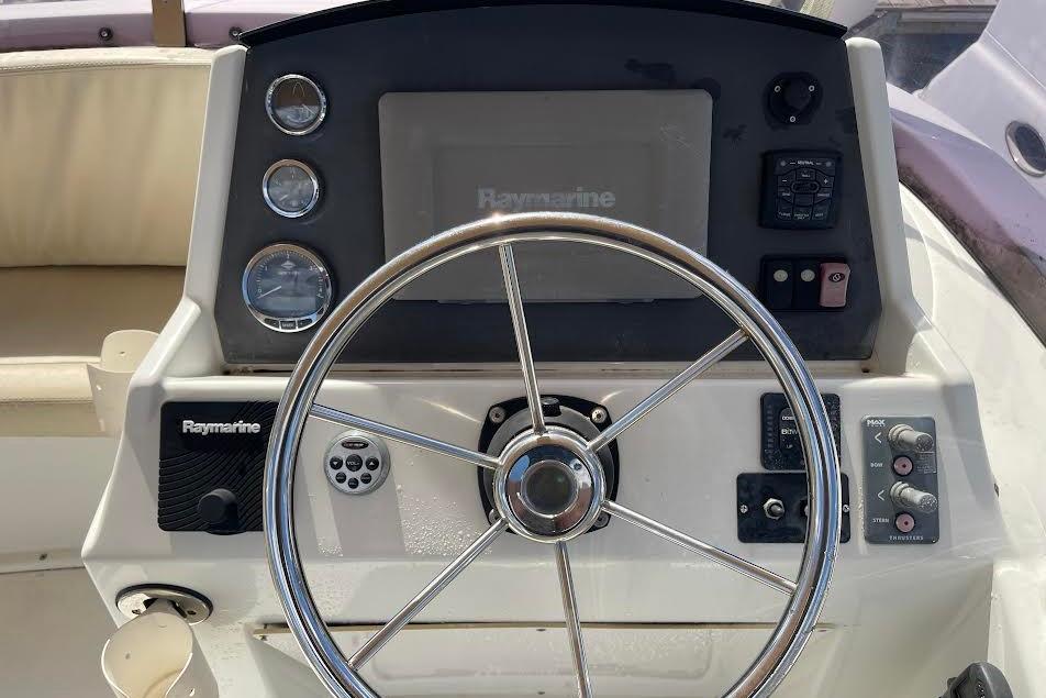 Steering console of 2012 Beneteau Swift Trawler 34 with Raymarine equipment.