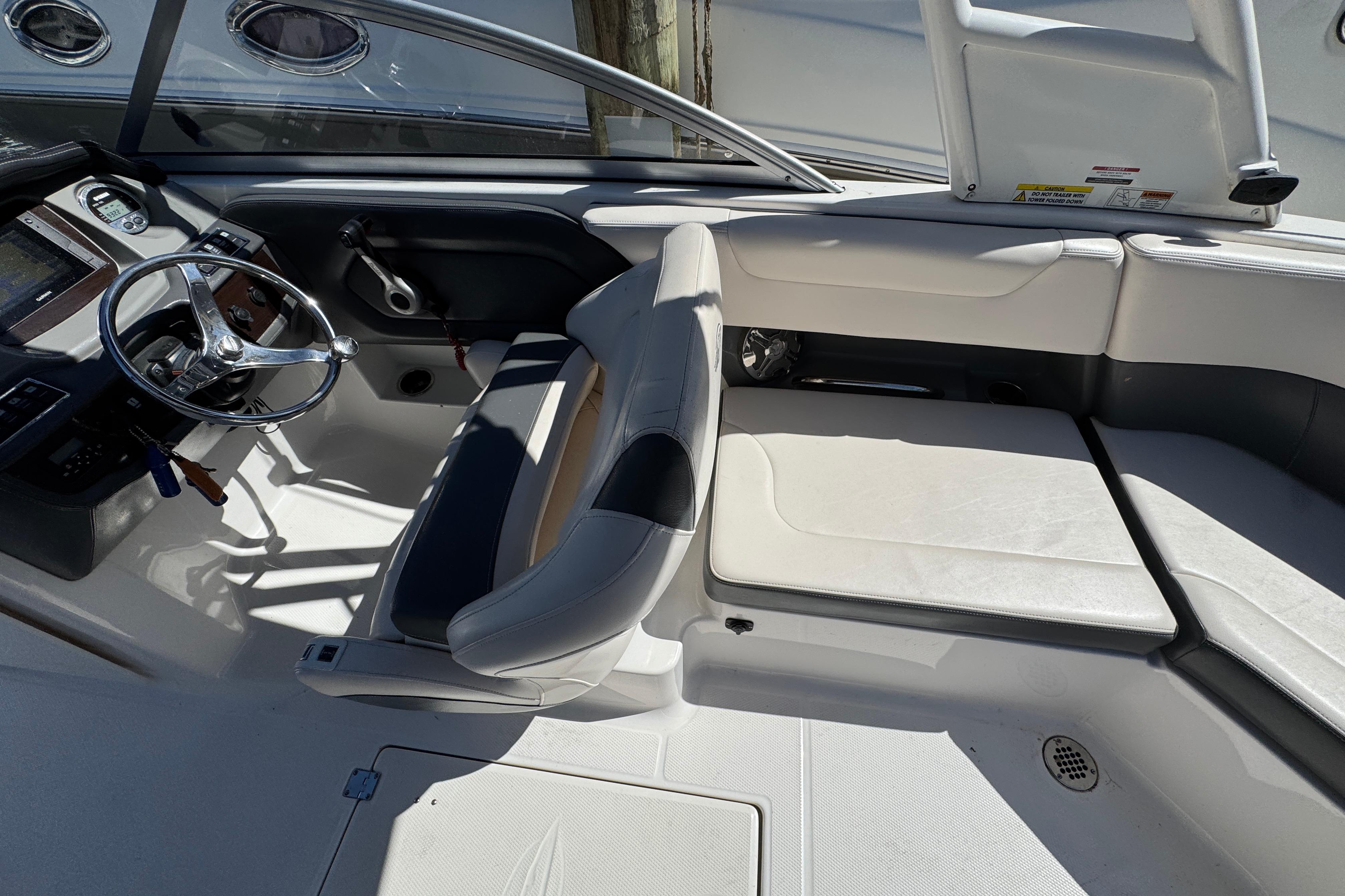 2018 Chaparral 250 Suncoast boat interior with steering wheel and seating area.