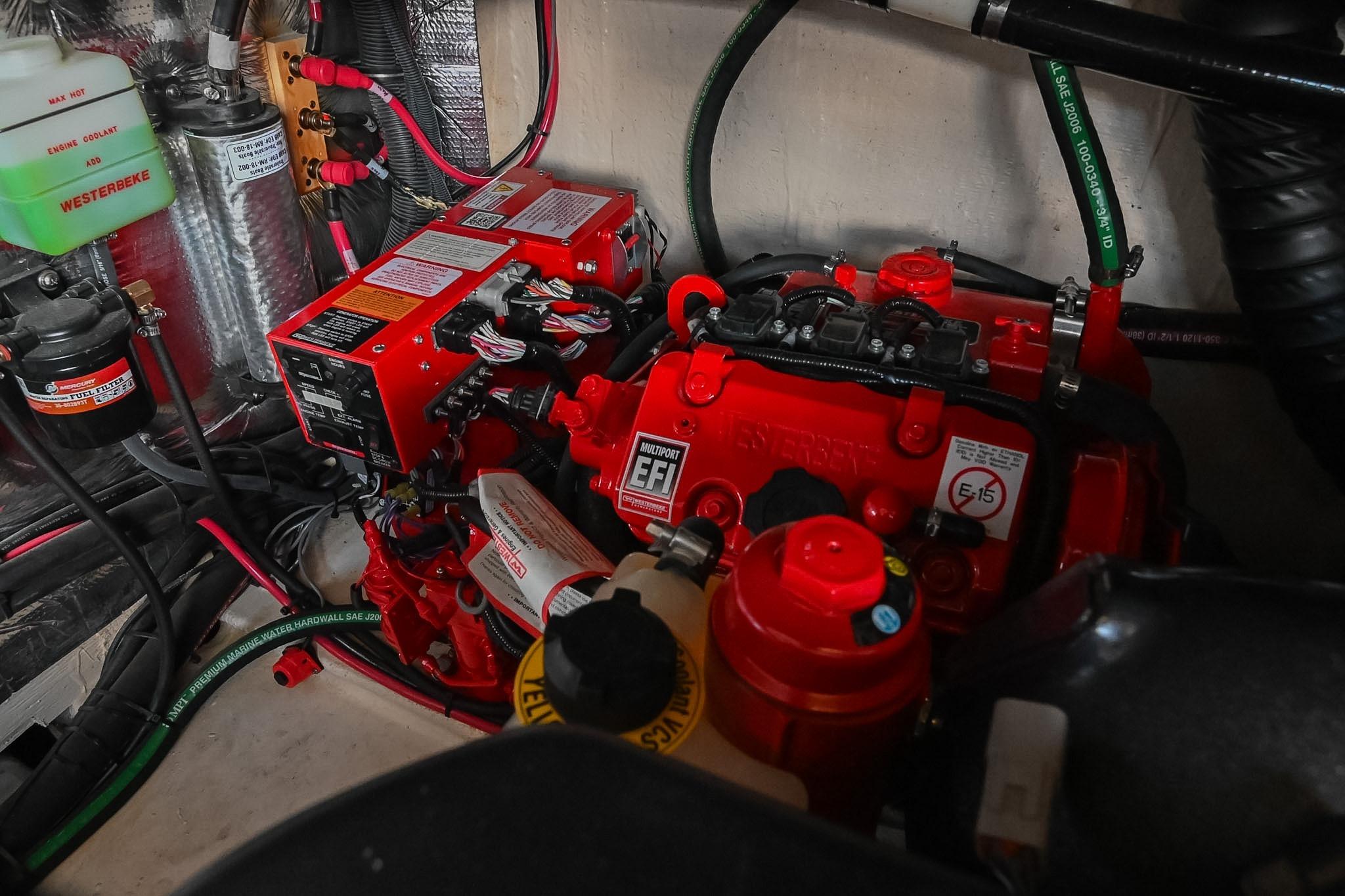 Engine compartment of a 2021 Regal 33 Express boat, featuring red mechanical components.
