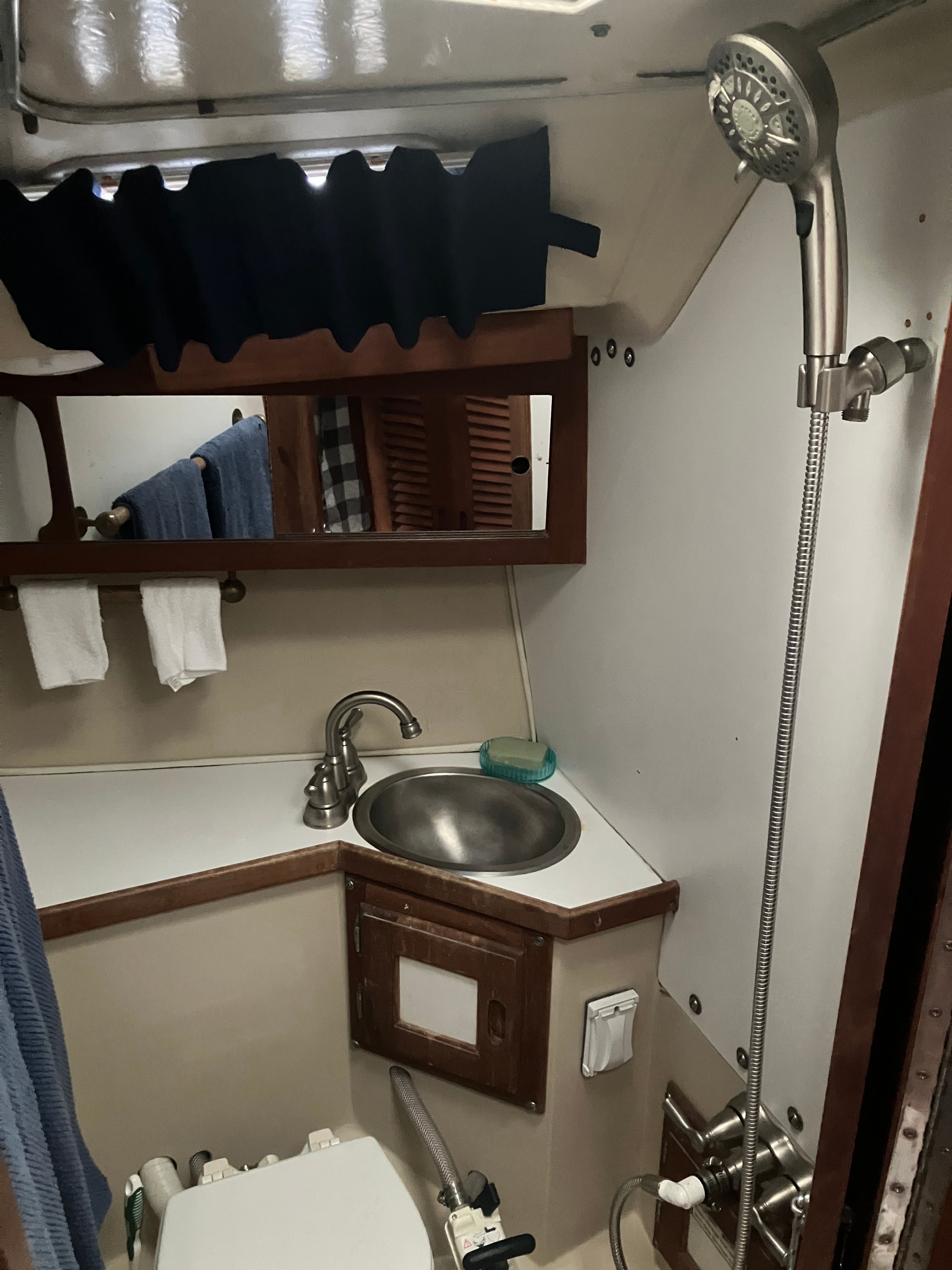 Bathroom in a 1984 Catalina 30 with sink, shower, and toilet.