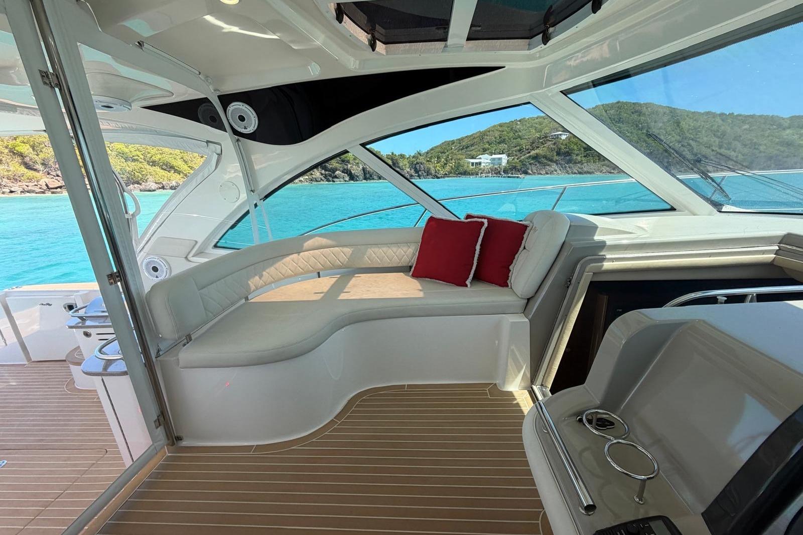 2006 Sea Ray 480 Sundancer yacht interior with plush seating and scenic ocean view.