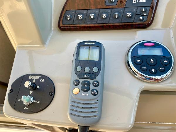 Control panel of a 2014 Sea Ray 330 Sundancer boat with various switches and devices.
