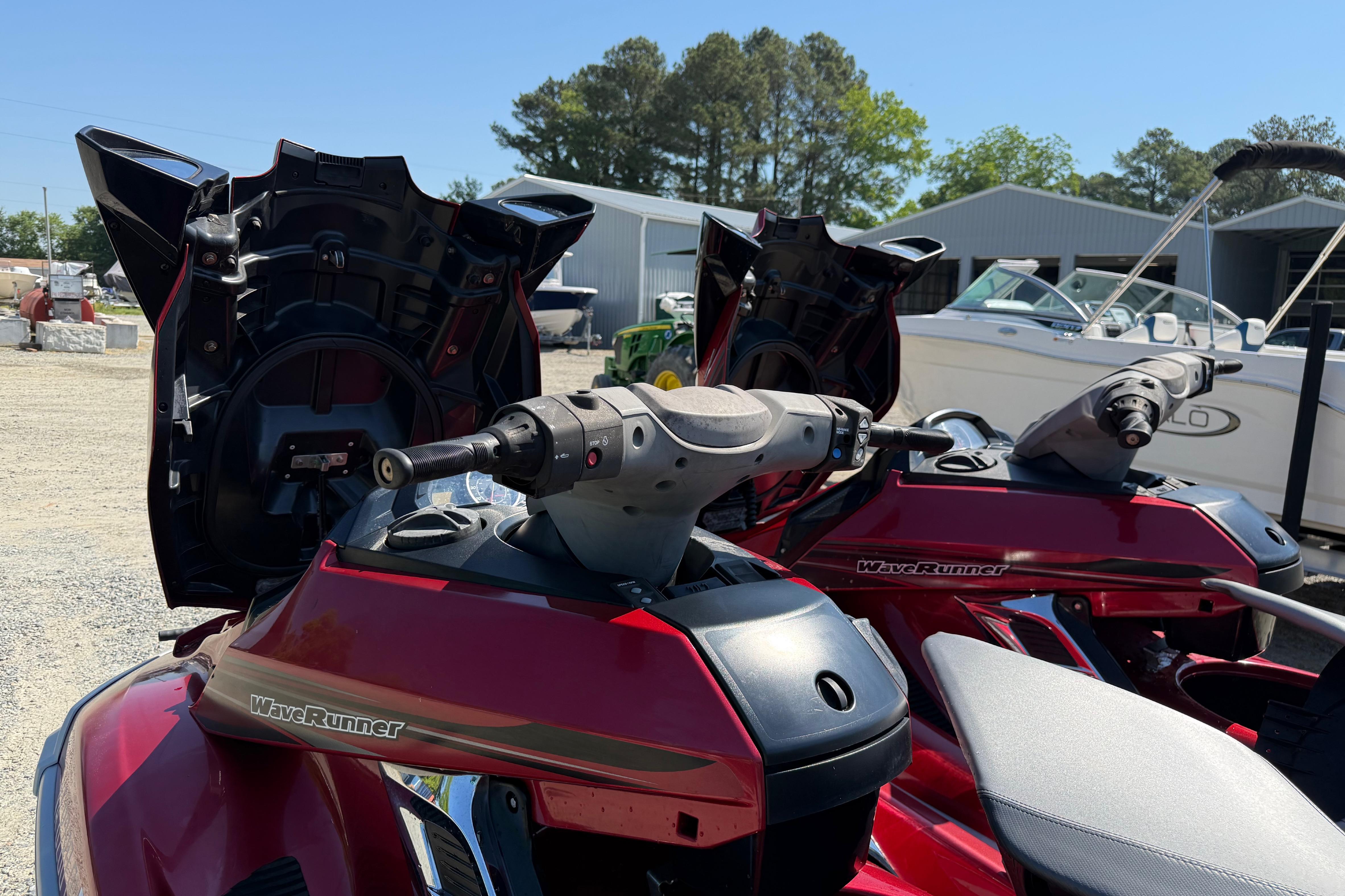 2013 Yamaha WaveRunner FX HO jet skis parked outdoors, with open storage compartments.