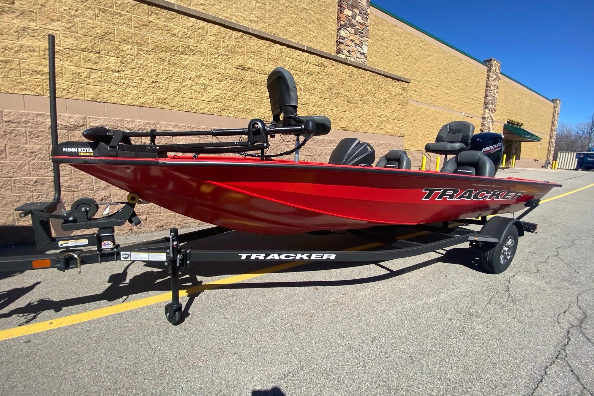 2026 Tracker Pro Team 175 boat in vibrant red on a trailer, parked outdoors.