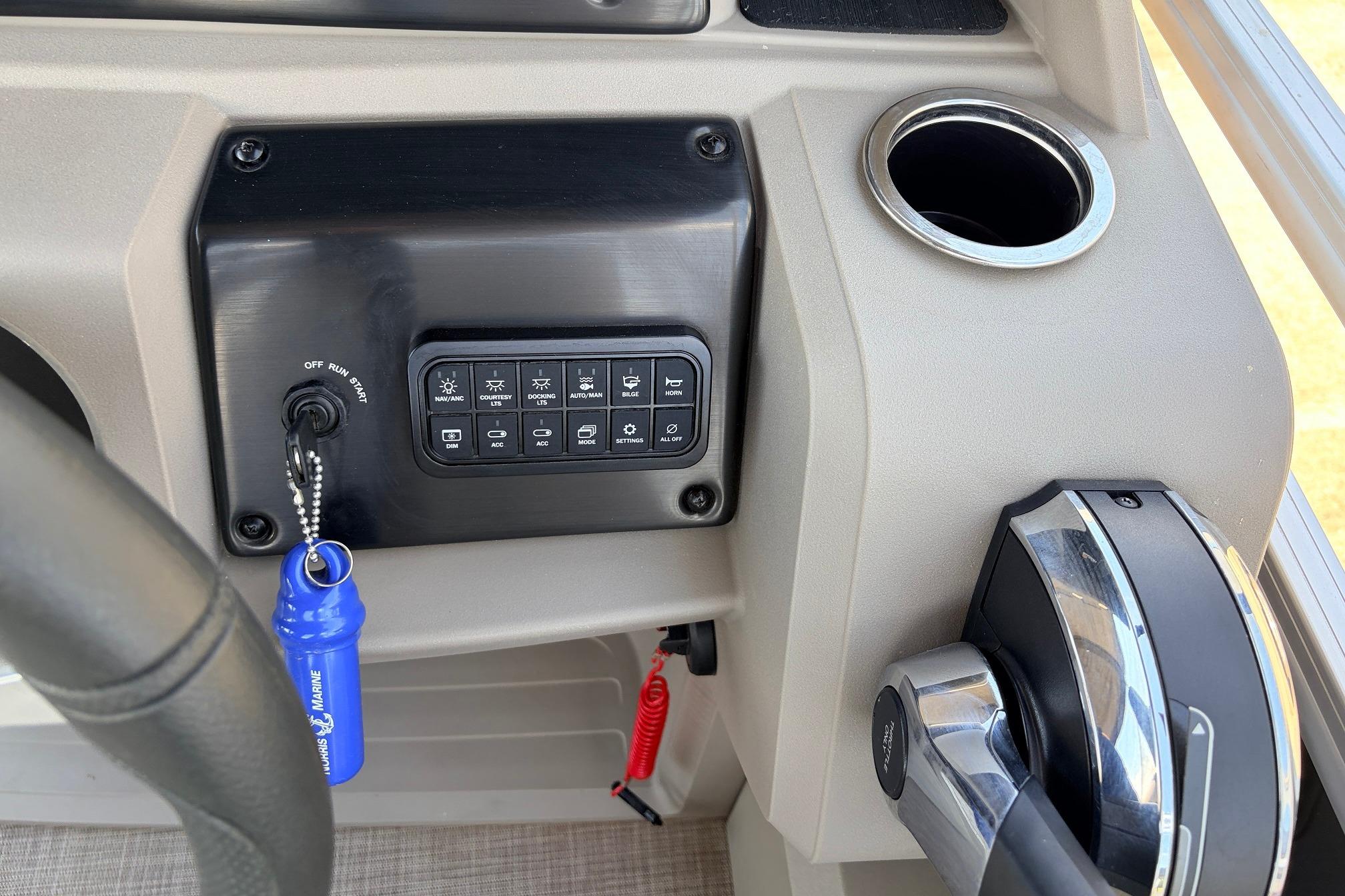 2024 Sun Tracker SportFish 22 XP3 dashboard with ignition, controls, and cup holder.