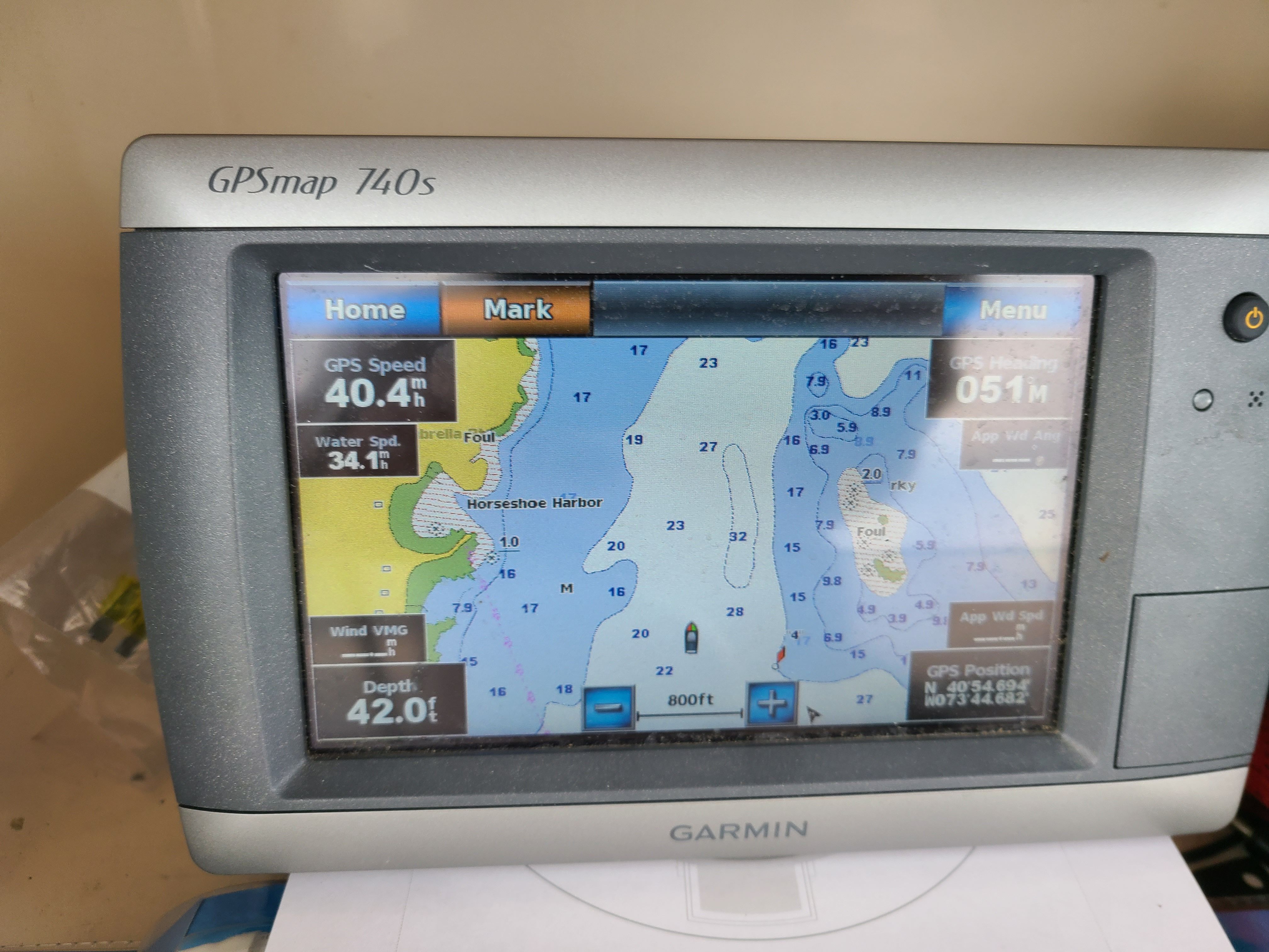 A Garmin GPSmap 740s displays a nautical chart with speed and depth information.