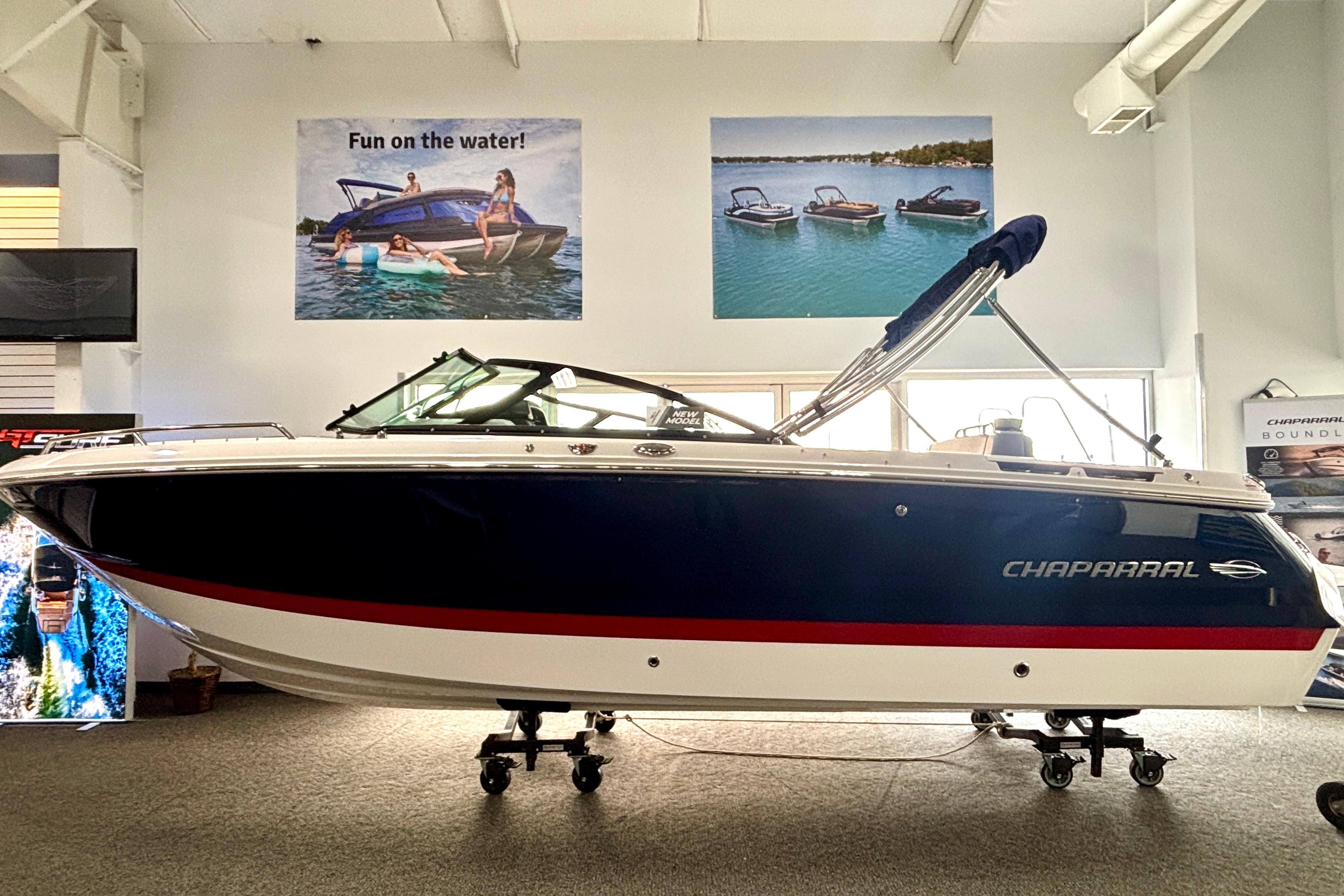 2026 Chaparral SSX 4 boat displayed indoors with promotional posters above.