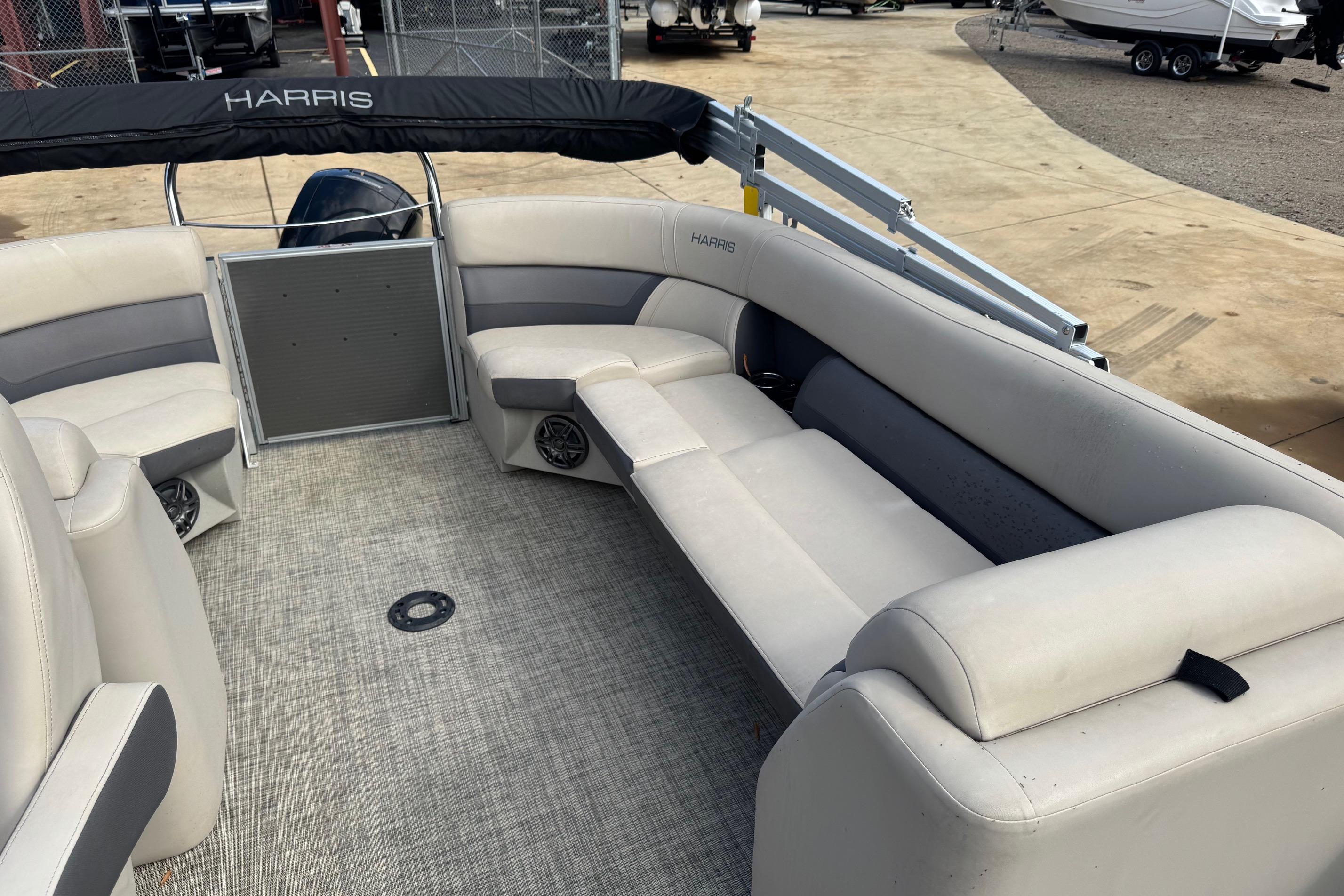 2023 Harris Cruiser 230 pontoon boat interior with beige seating and carpeted floor.