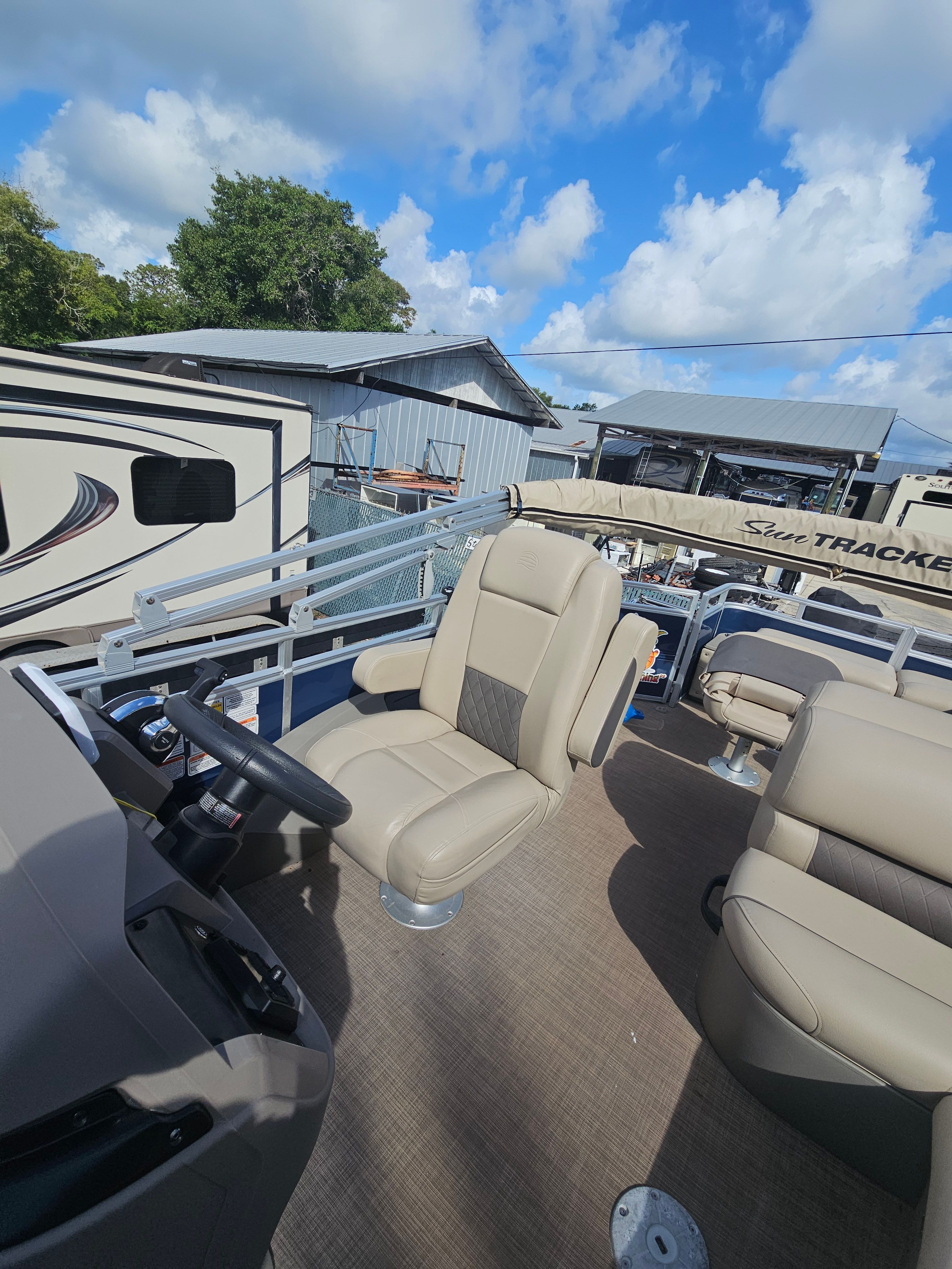 2024 Sun Tracker Fishin' Barge 22 DLX interior view on a sunny day.
