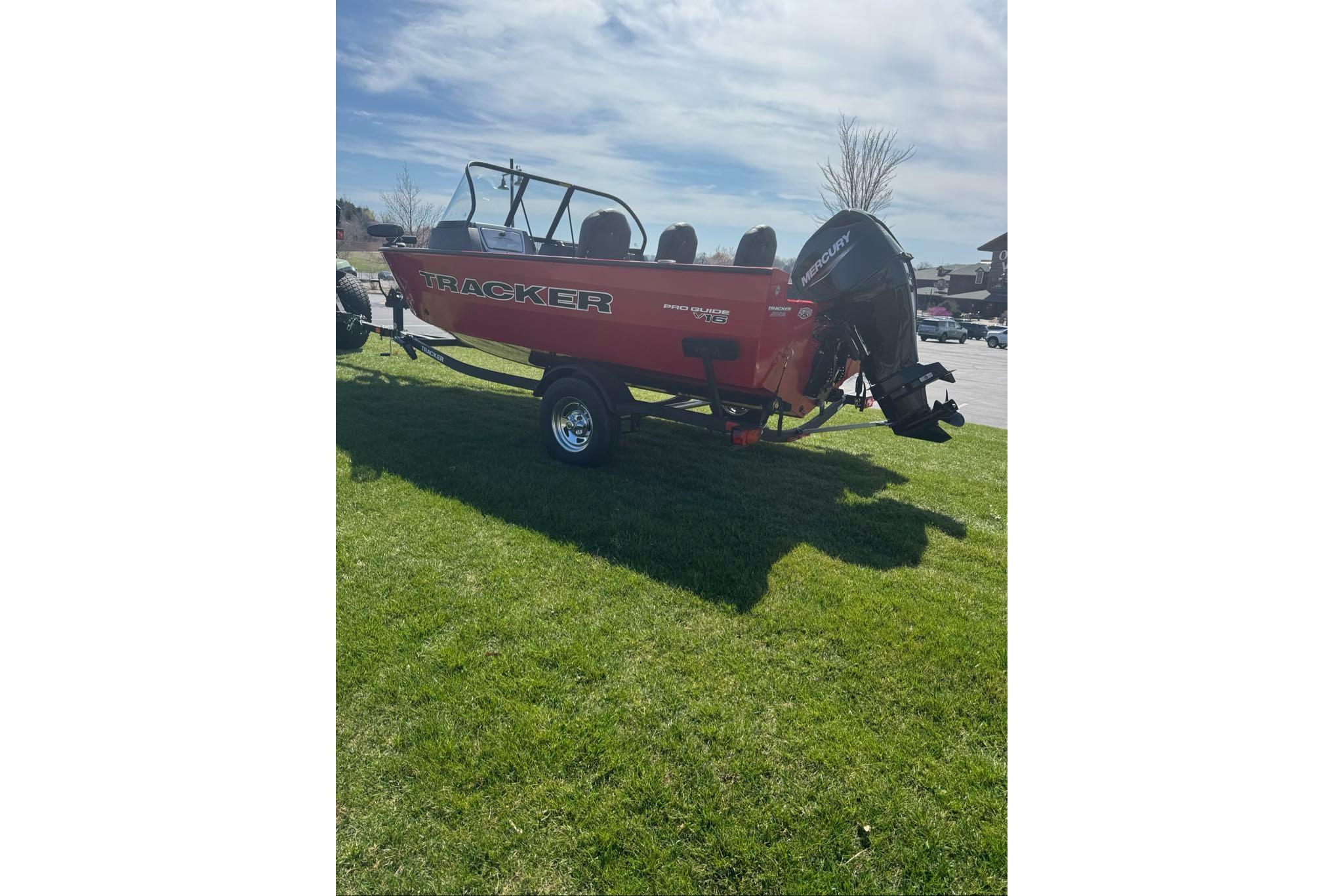 2026 Tracker Pro Guide V-16 WT boat on grass, featuring Mercury outboard motor.