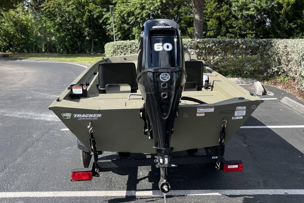 2026 Tracker Grizzly 1754 SC boat with Mercury 60 engine in parking lot.