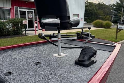2026 Tracker Pro 170 boat with fishing seat and pedal, parked outside a building.