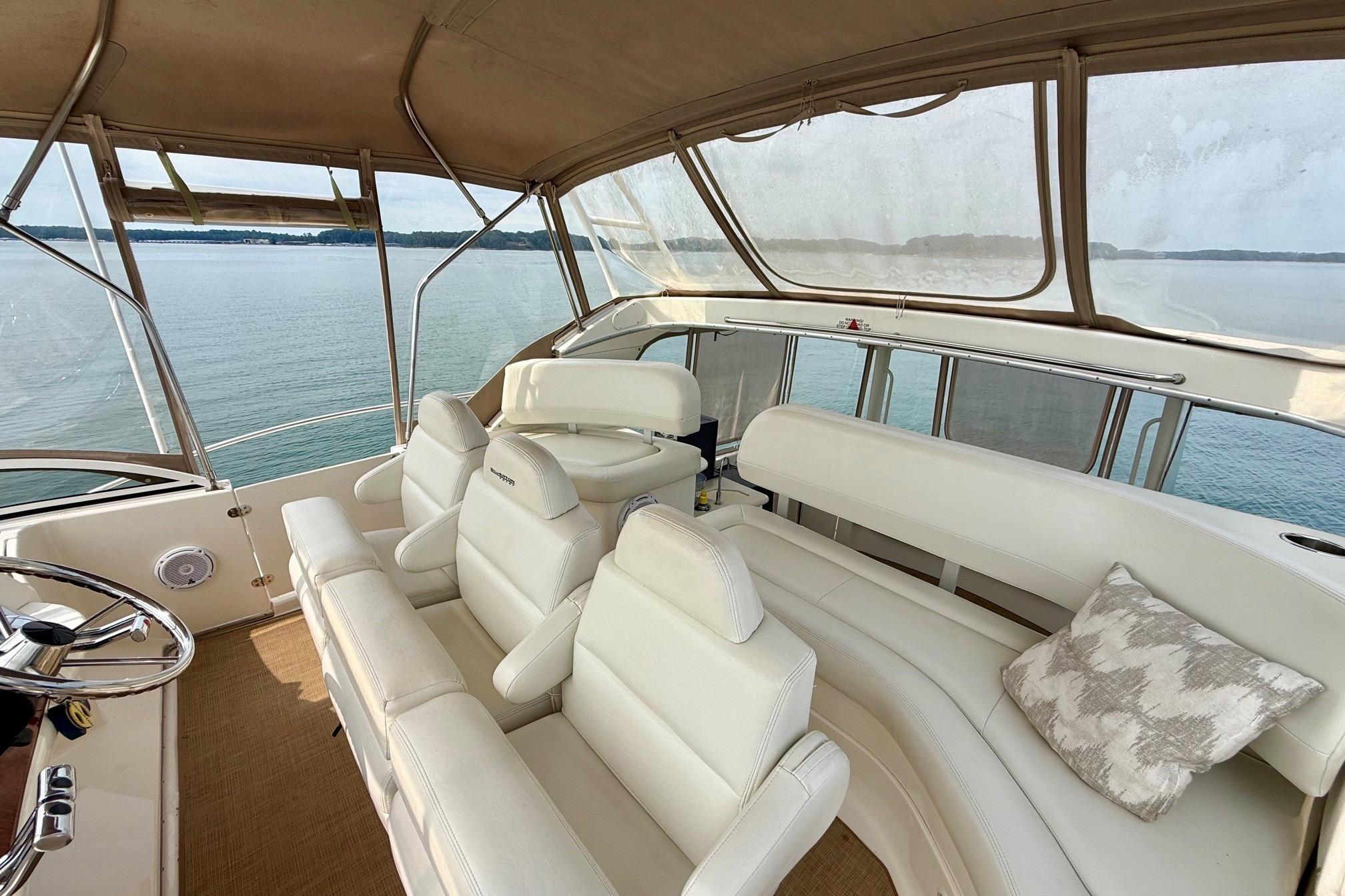 2004 Silverton 39 Motor Yacht interior with white seating, overlooking serene water view.