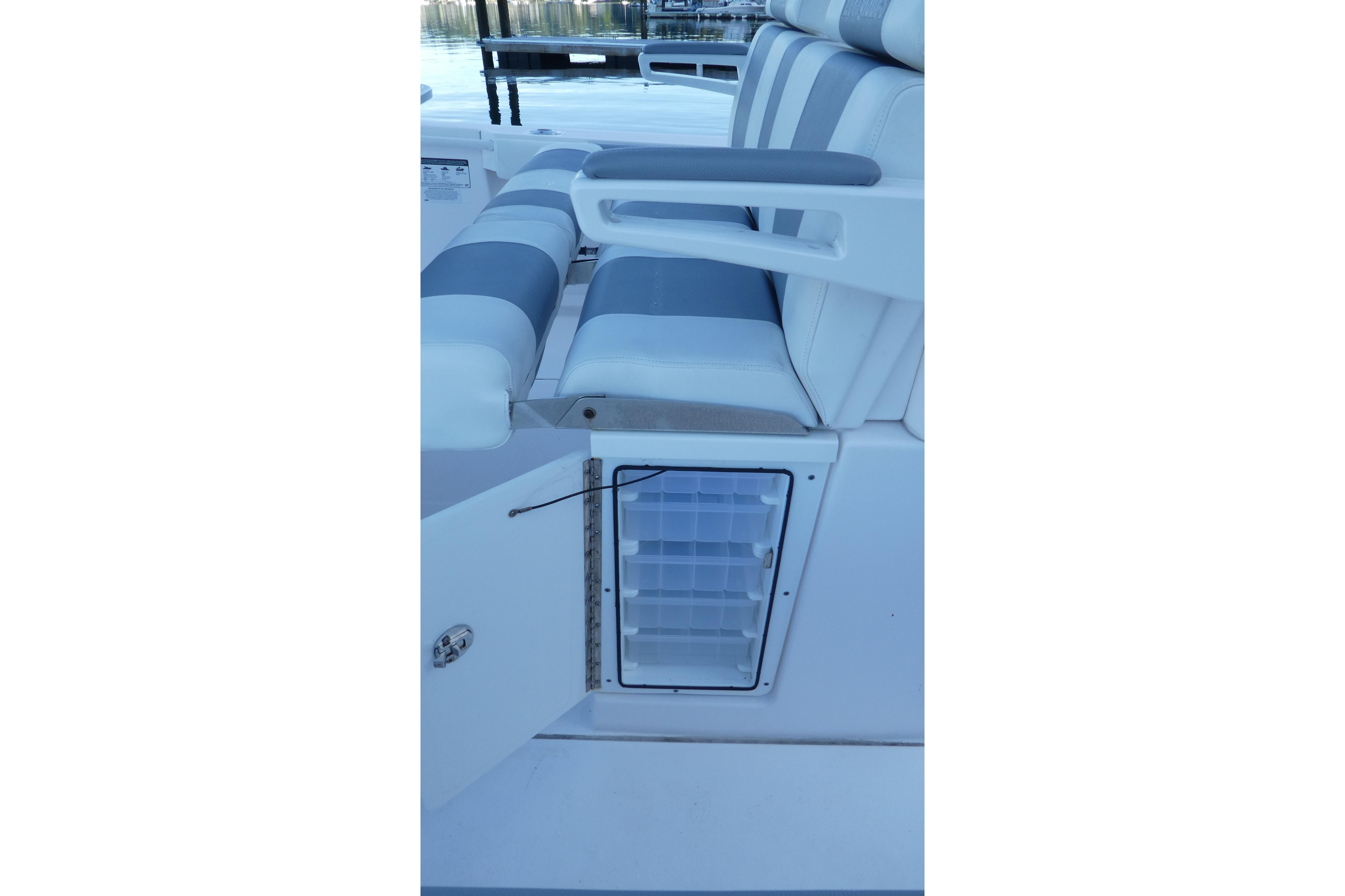 2015 Everglades 295 Center Console seating with storage compartment open.