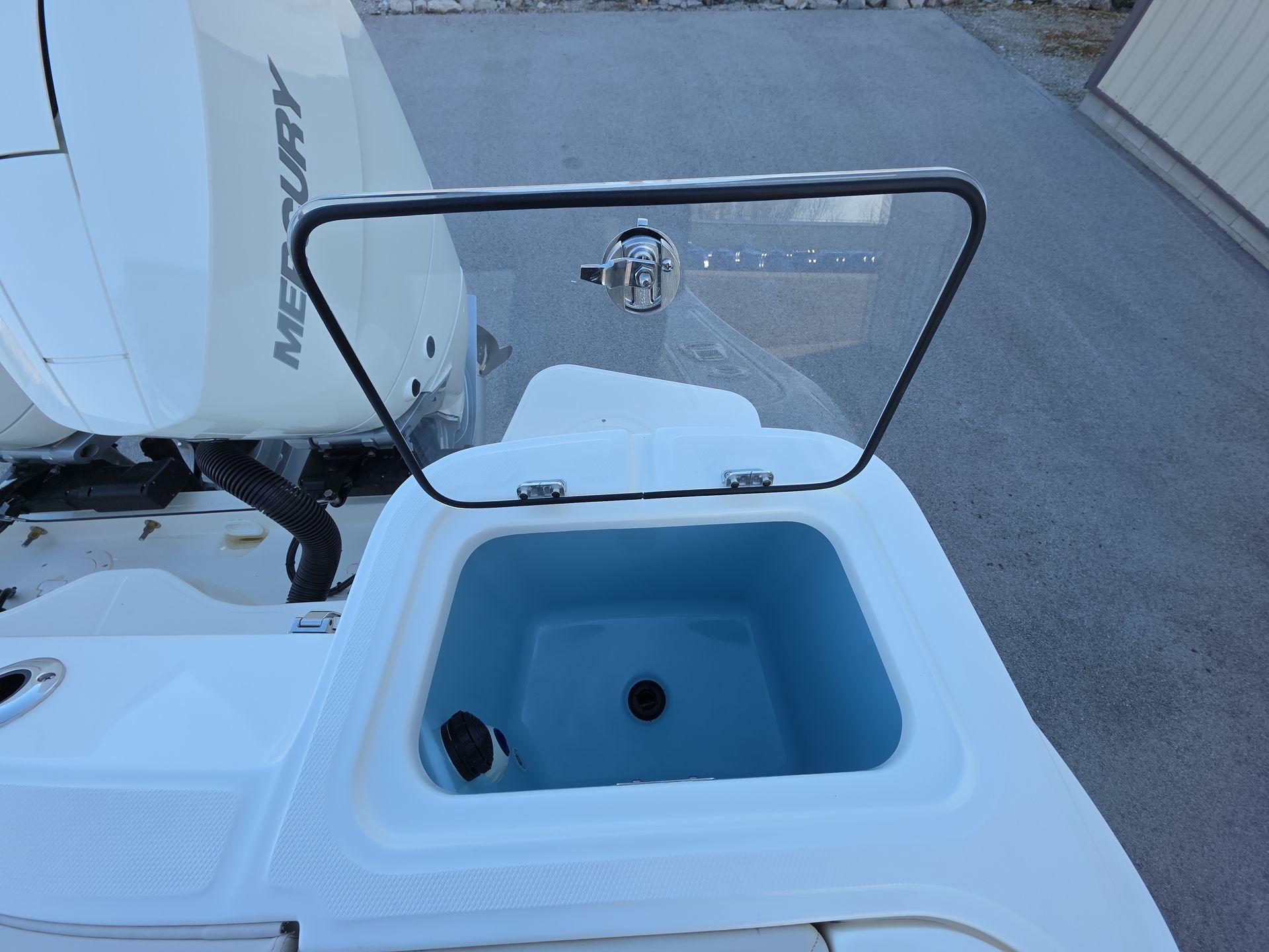 Boston Whaler 325 Conquest 2025 livewell with open lid, showcasing interior.