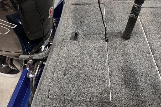 2024 Lowe Stinger 198 boat deck with carpeted surface and motor detail.
