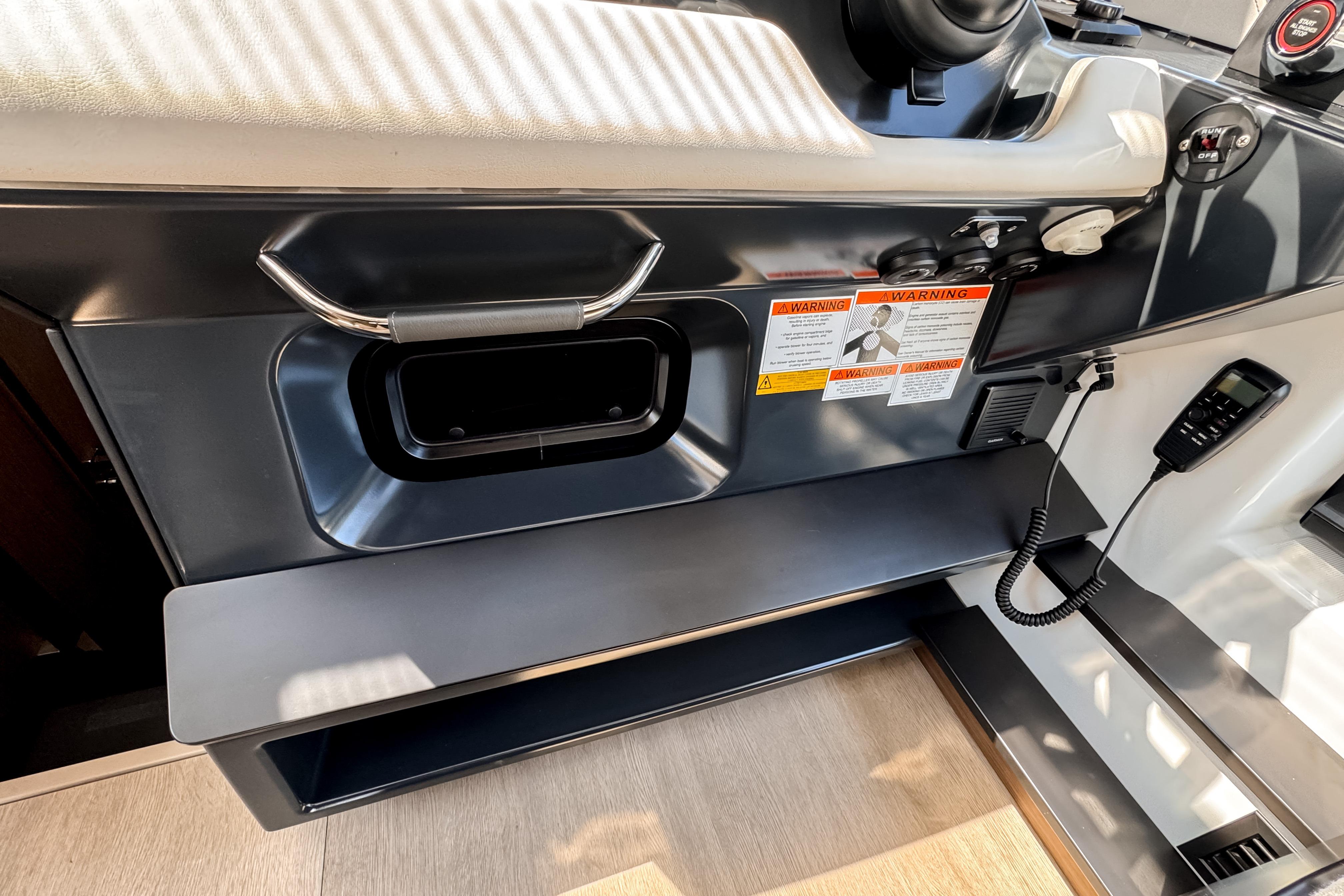 Interior of Wellcraft 44 Explorer 2026 with control console and warning labels.