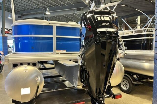 2026 Sun Tracker Party Barge 20 DLX pontoon boat with Mercury 115 engine in showroom.