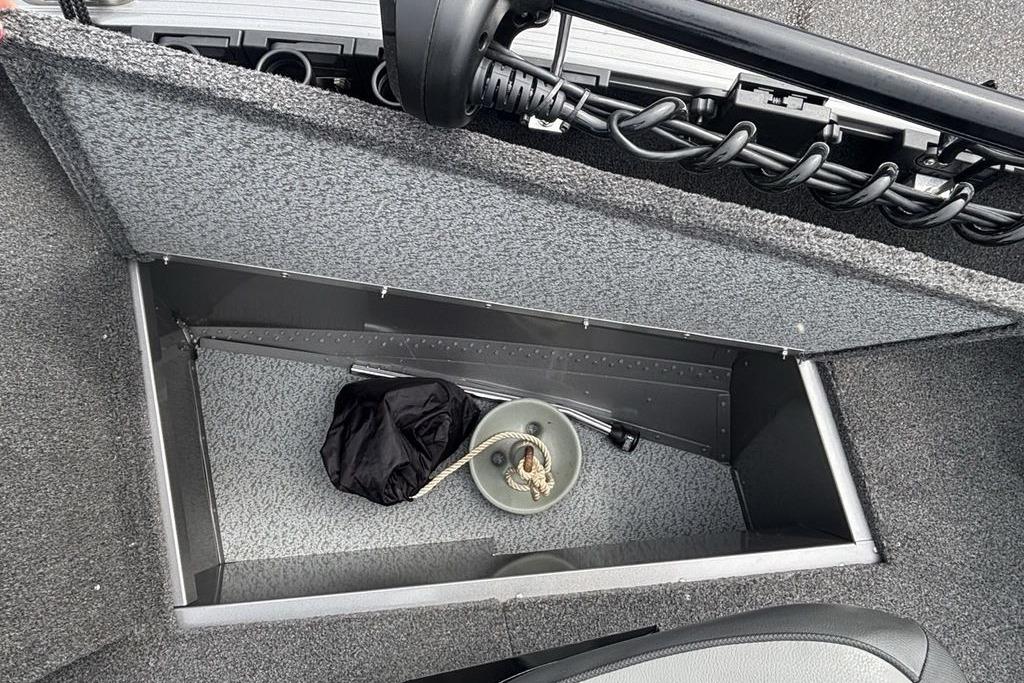 Storage compartment in 2021 Lund 1675 Adventure Sport boat, featuring anchor and rope.