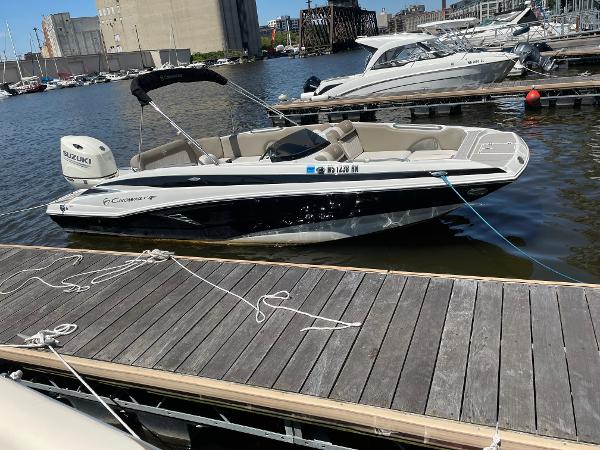2020 Crownline E 205 XS boat docked at marina with Suzuki engine.