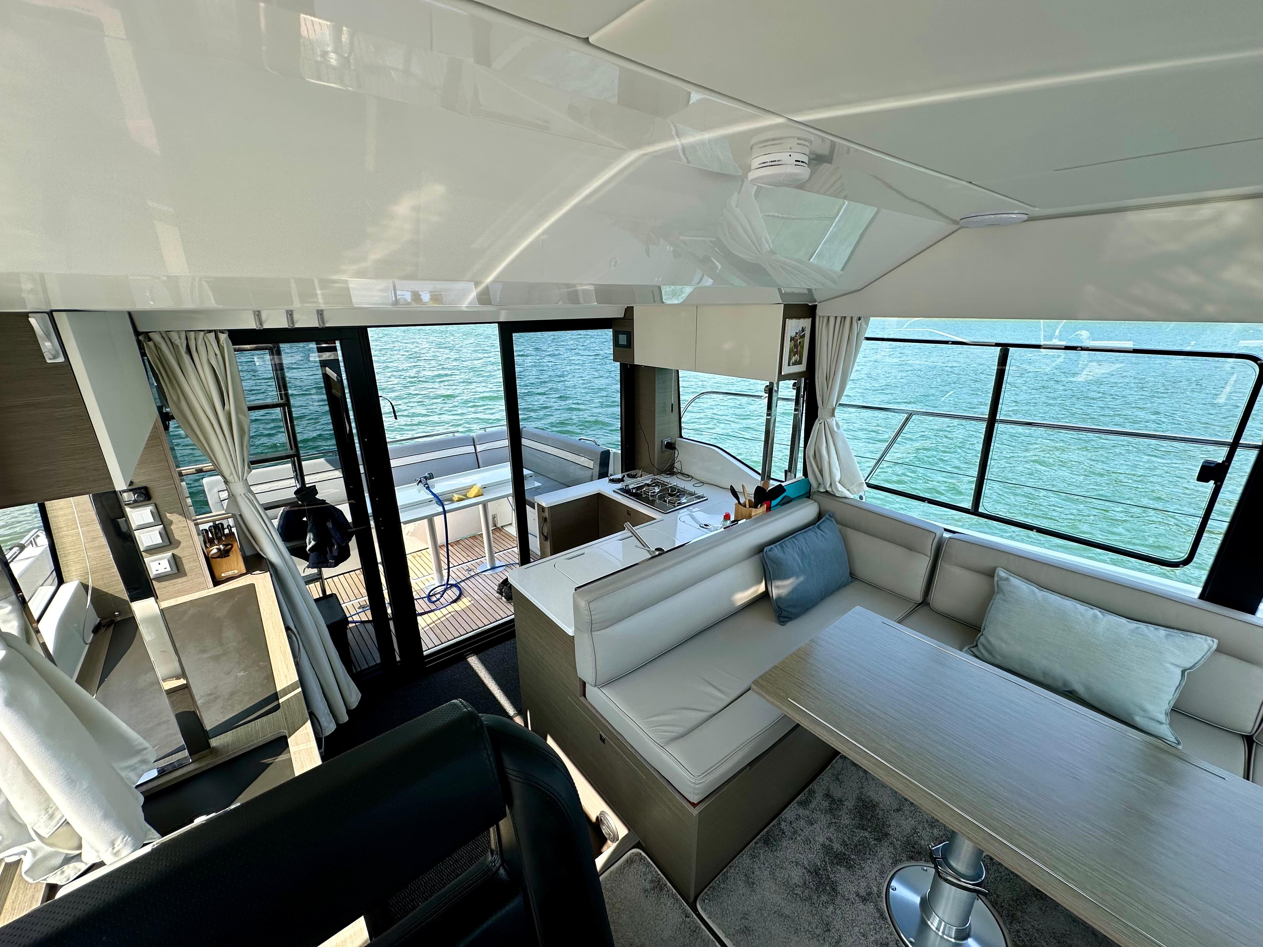 Interior of 2024 Jeanneau Merry Fisher 1295 Flybridge, featuring modern seating and ocean view.
