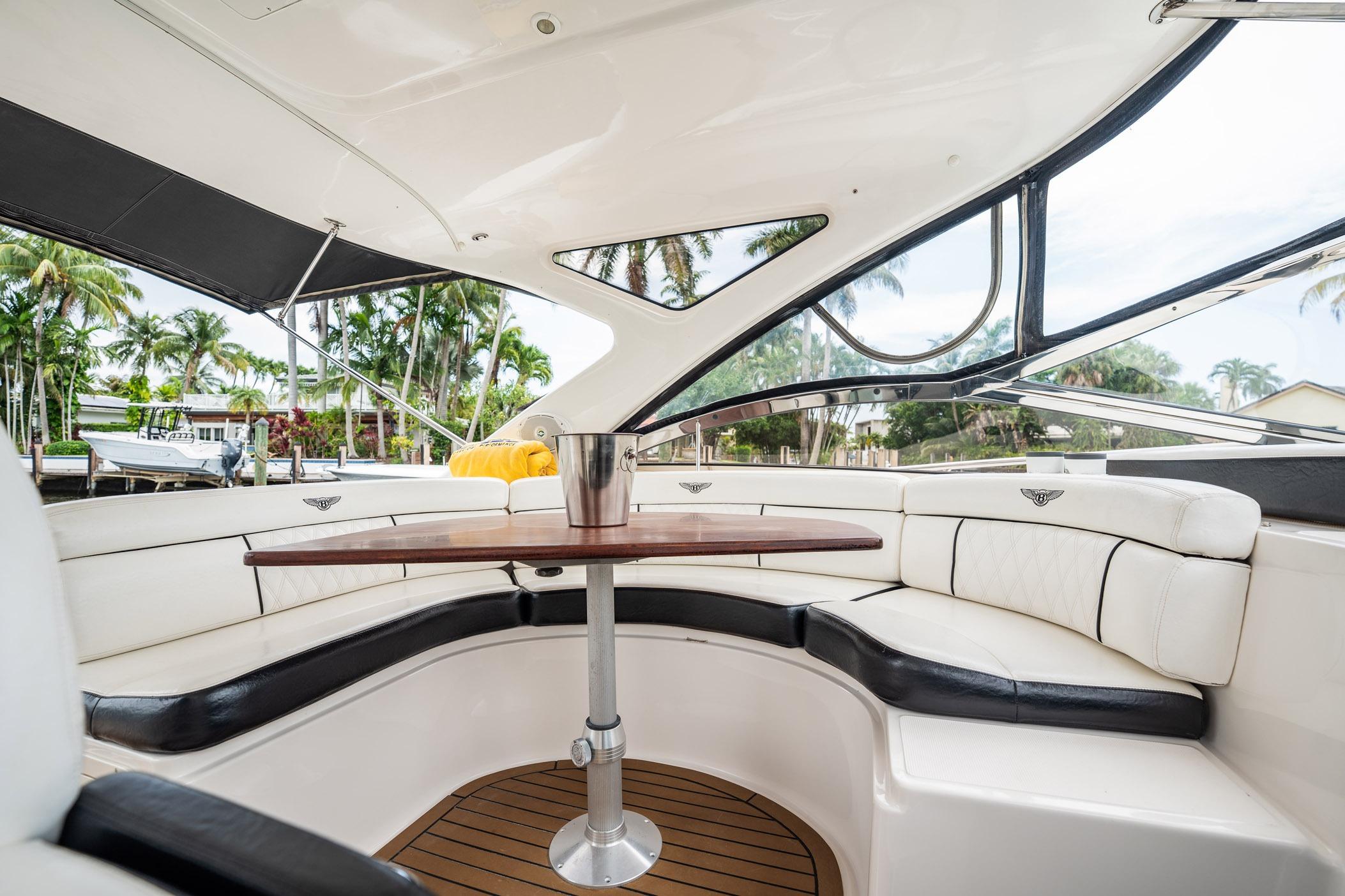 Luxurious interior of 2008 Regal Commodore 4460 yacht with elegant seating and table.