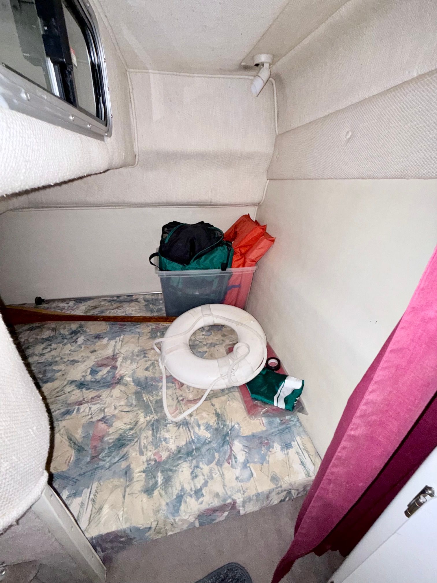 Interior of a 1997 Chaparral Signature 260 with a life ring and bags.