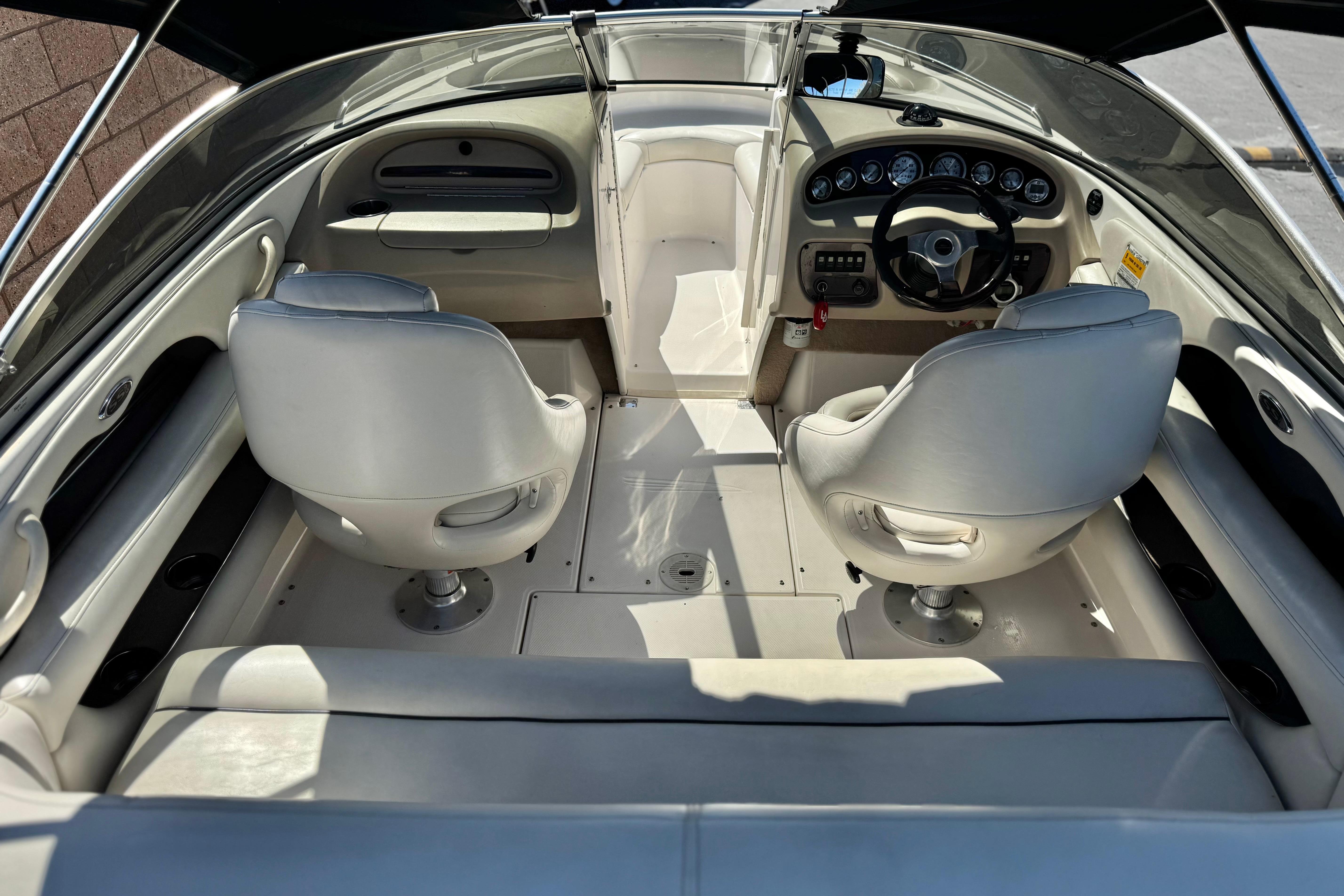 Interior of a 2002 Chaparral 186 SSi boat with white seating and dashboard.