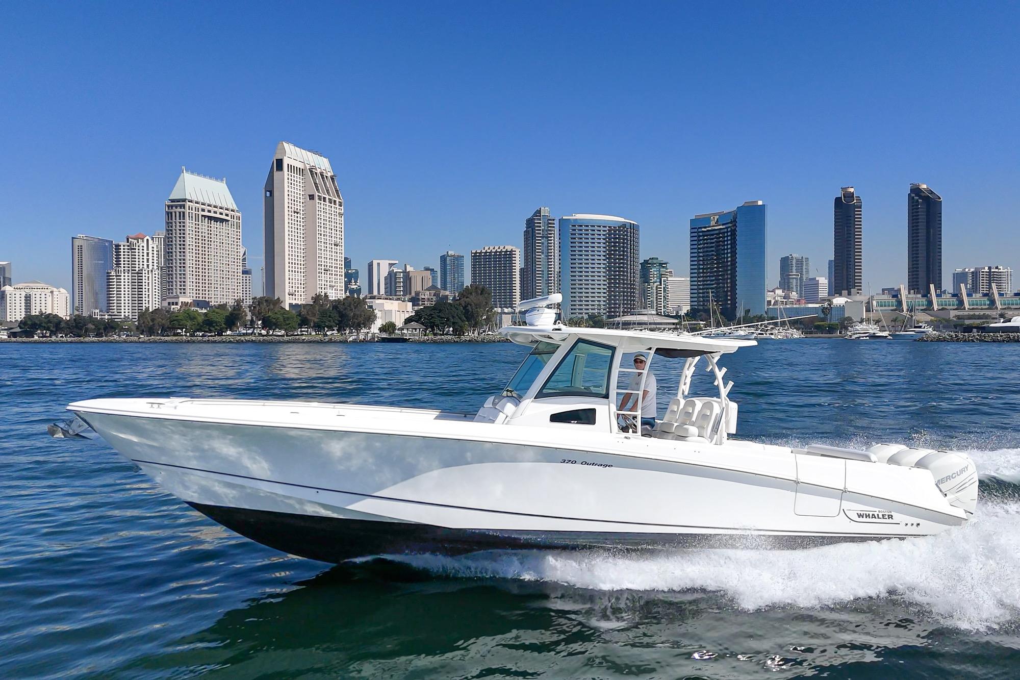 2015 Boston Whaler 370 Outrage cruising in urban waterfront setting.
