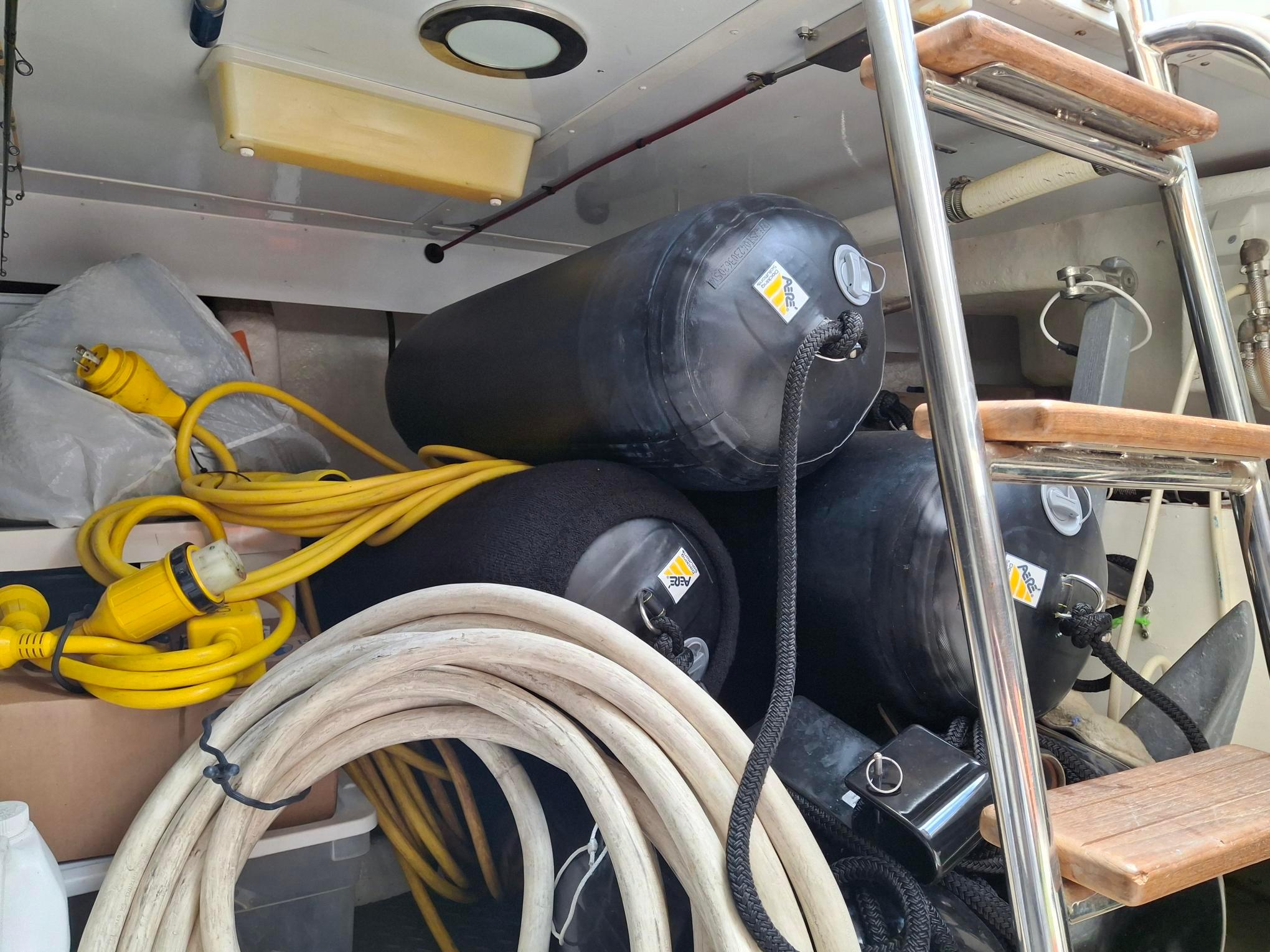 Storage area on a 2004 Ocean Alexander 64 Pilothouse with cables and fenders.