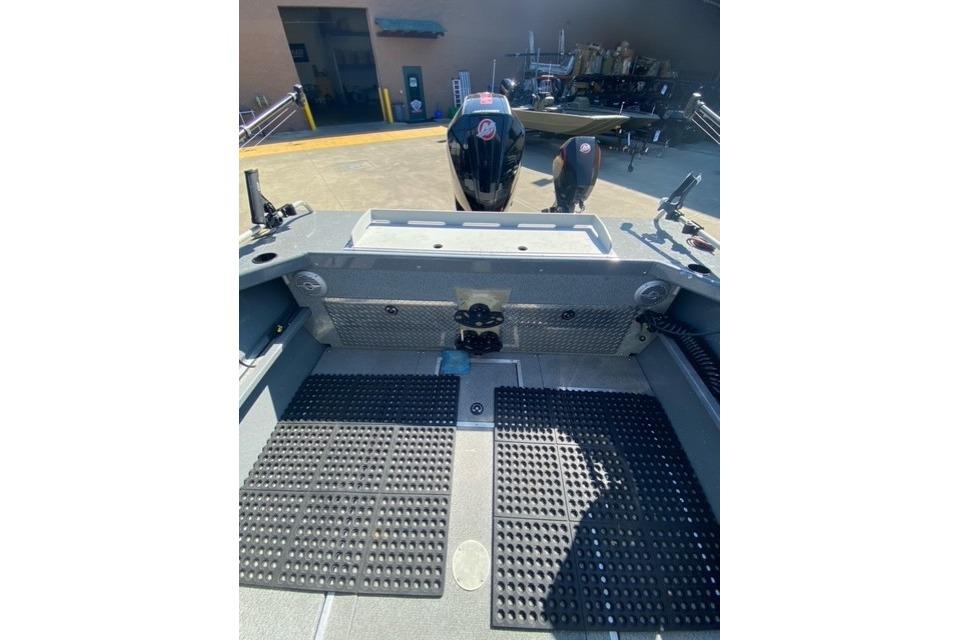 2023 Spartan 200 Astoria boat interior with rubber flooring and visible outboard motor.