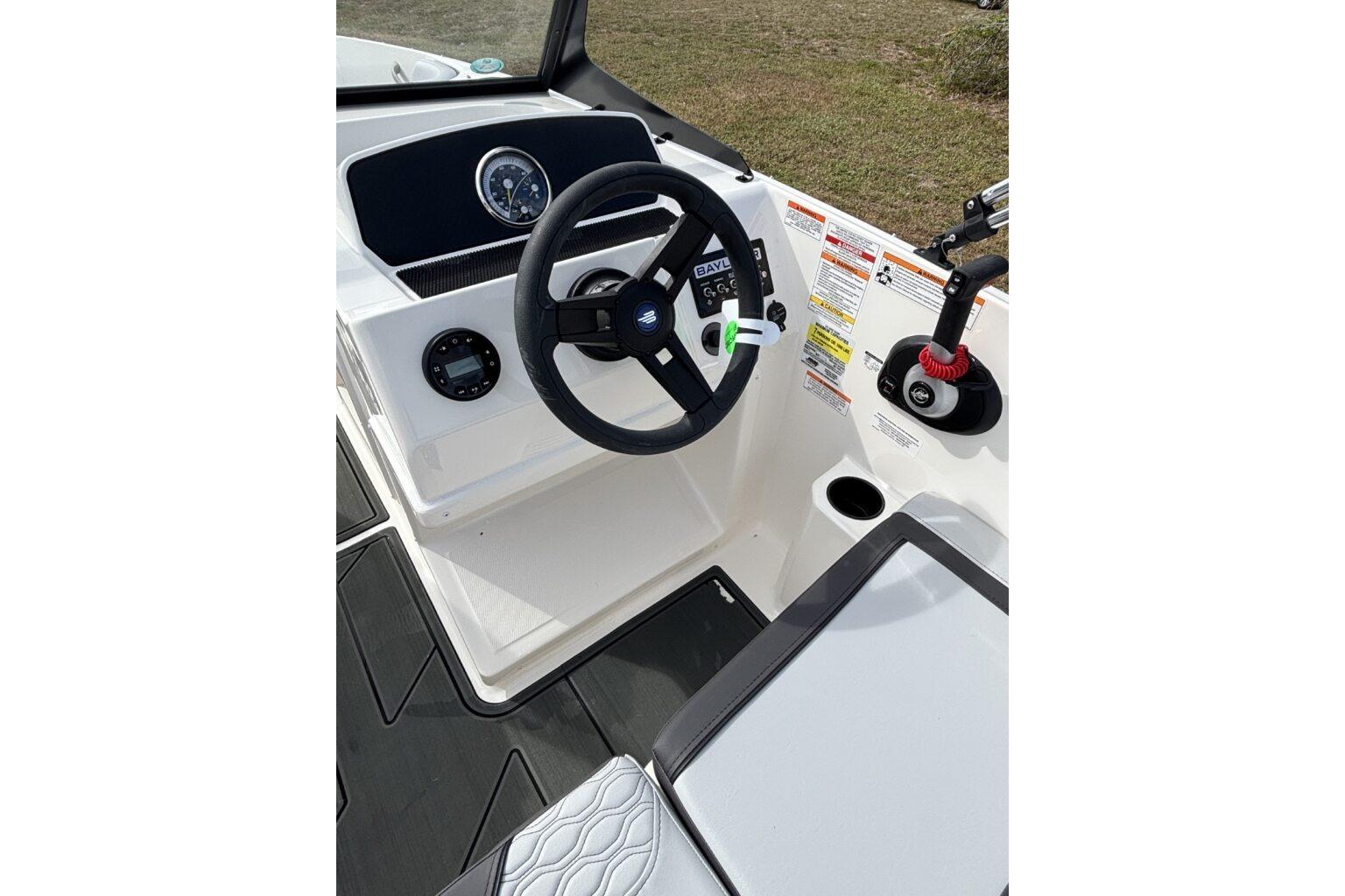2025 Bayliner Element M17 boat cockpit with steering wheel and control panel.