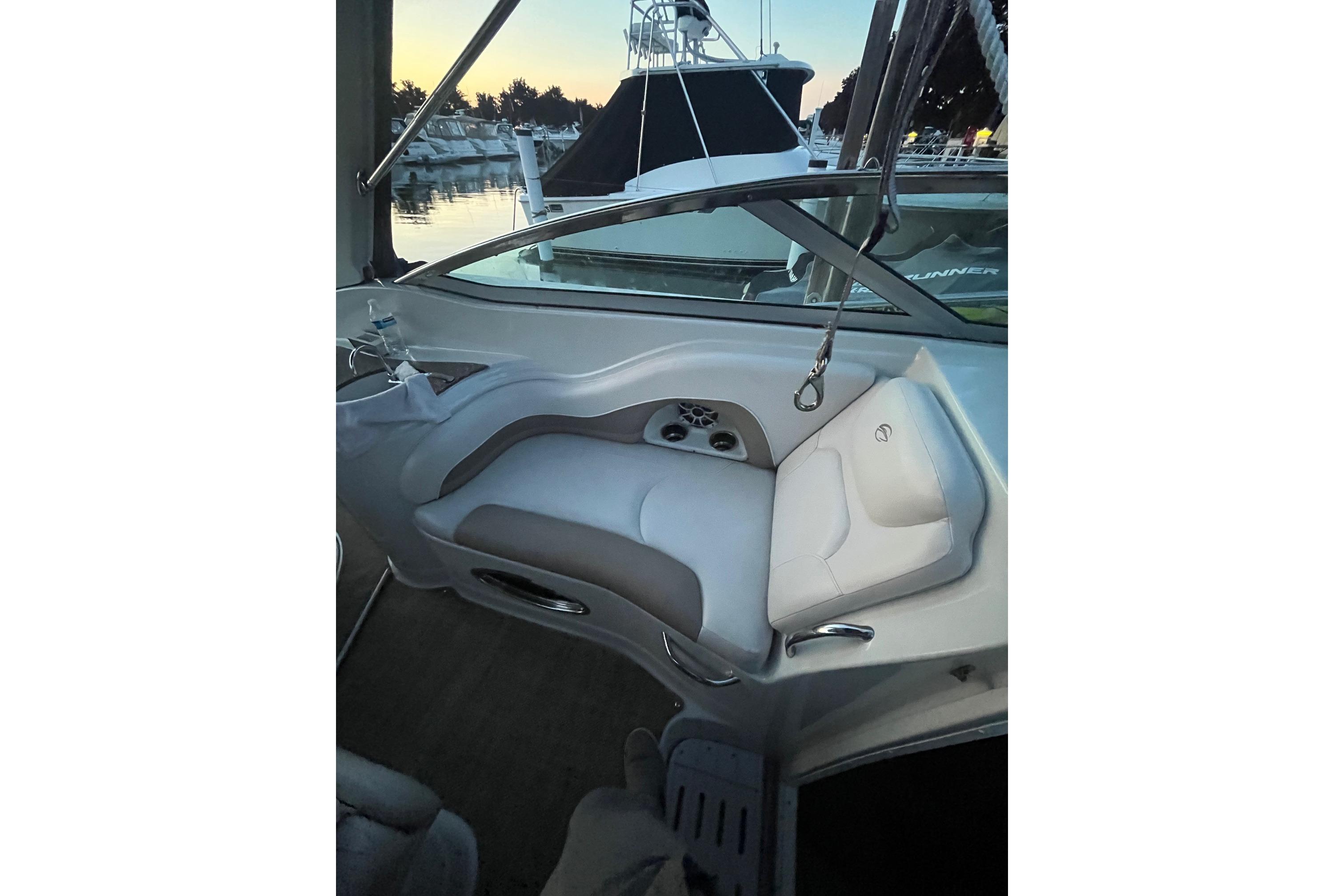 2016 Crownline 264 CR boat interior with white seating and marina view.