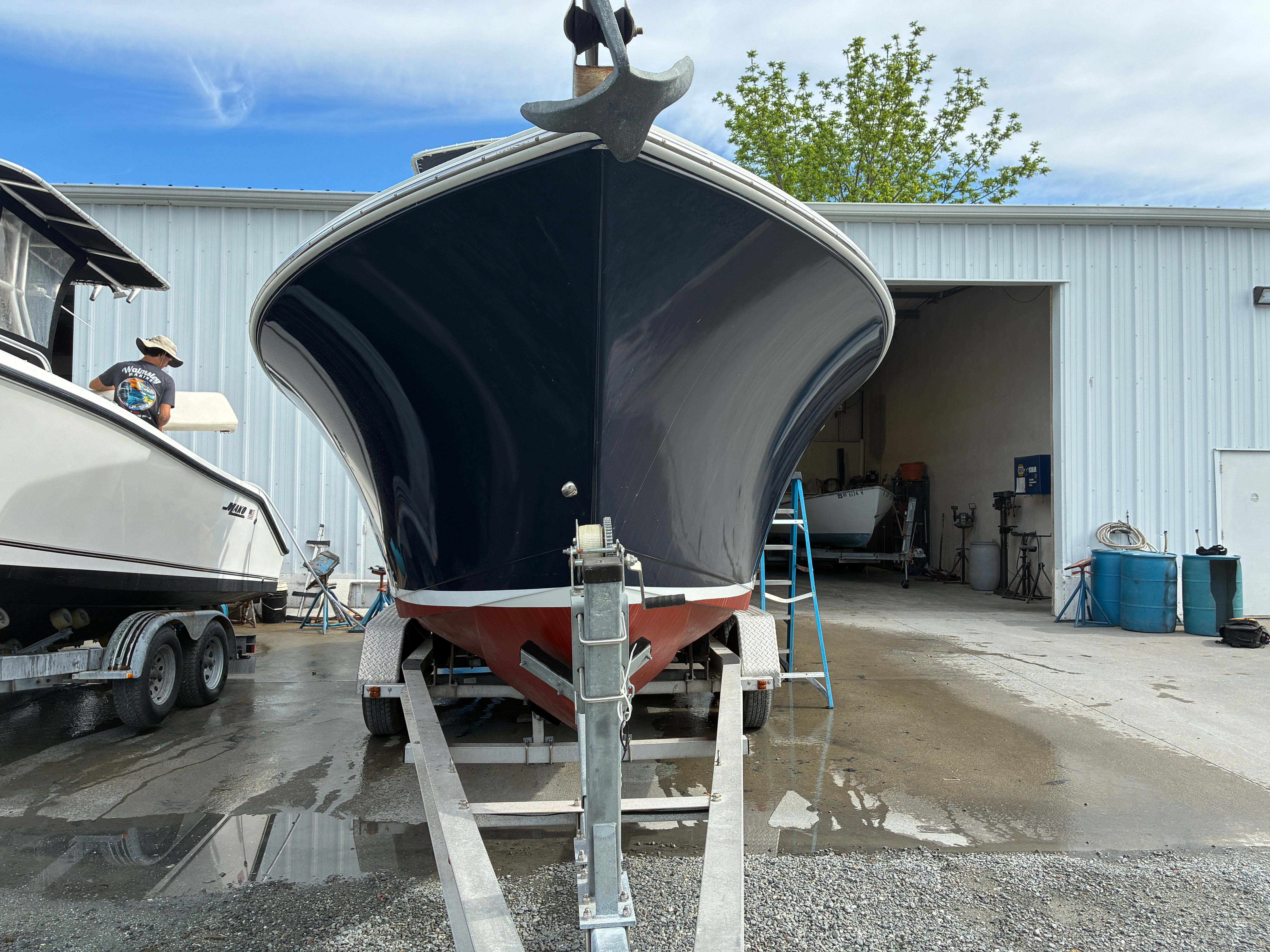2007 Sailfish 2660 boat on trailer outside workshop.
