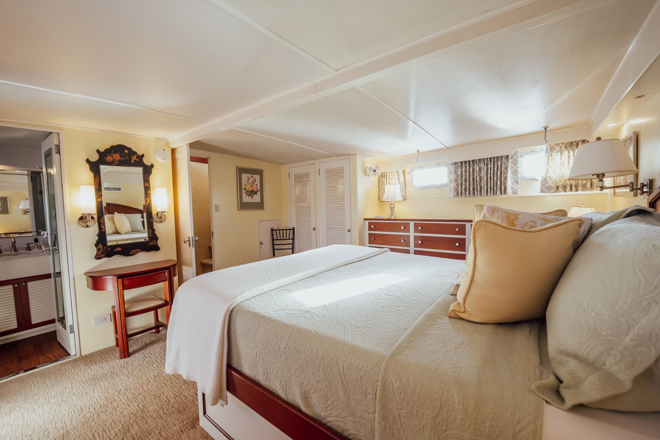 Luxurious bedroom interior of 1972 Trumpy 72 Motor Yacht with elegant decor and natural light.