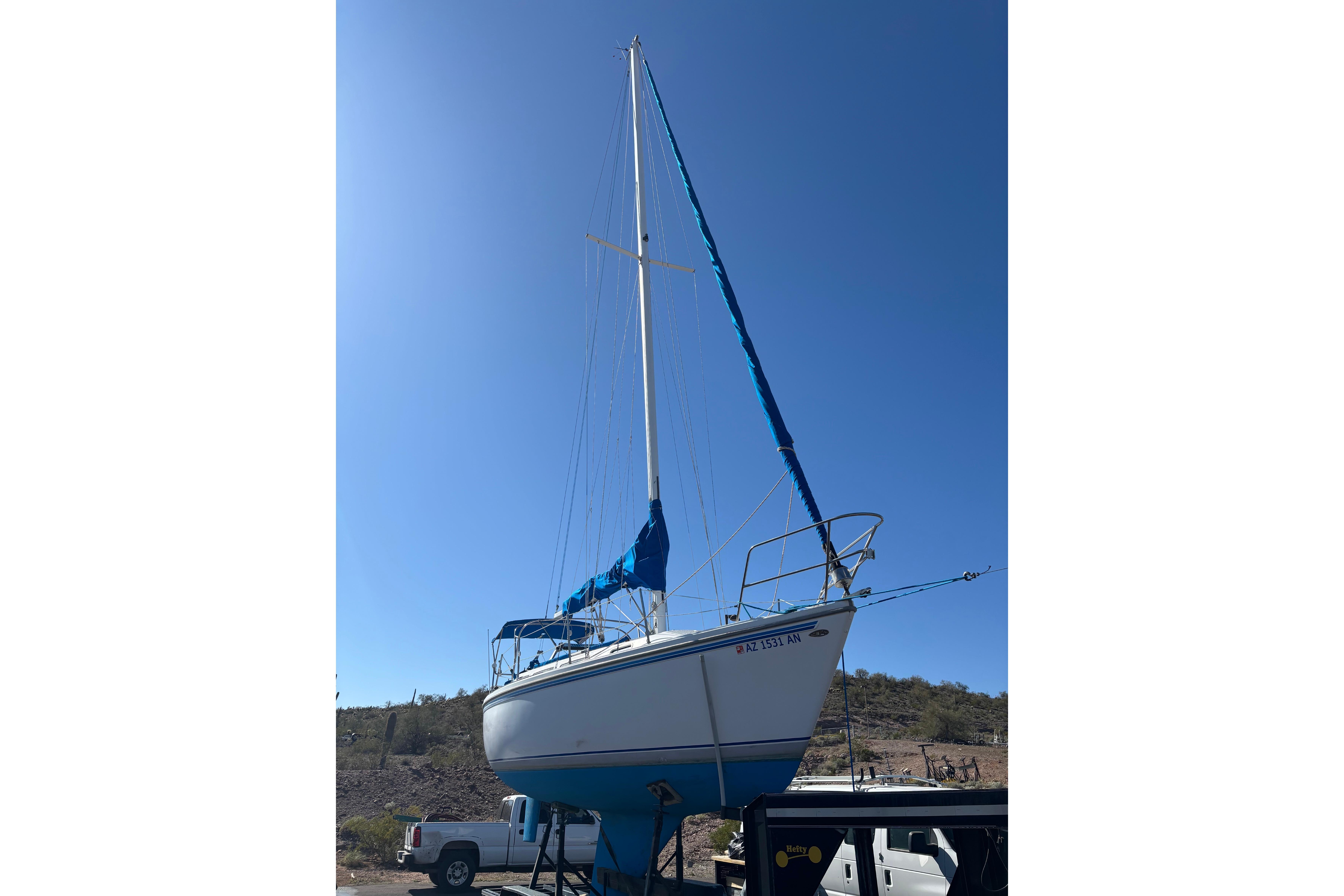 1980 Catalina 30 sailboat on trailer under clear blue sky.