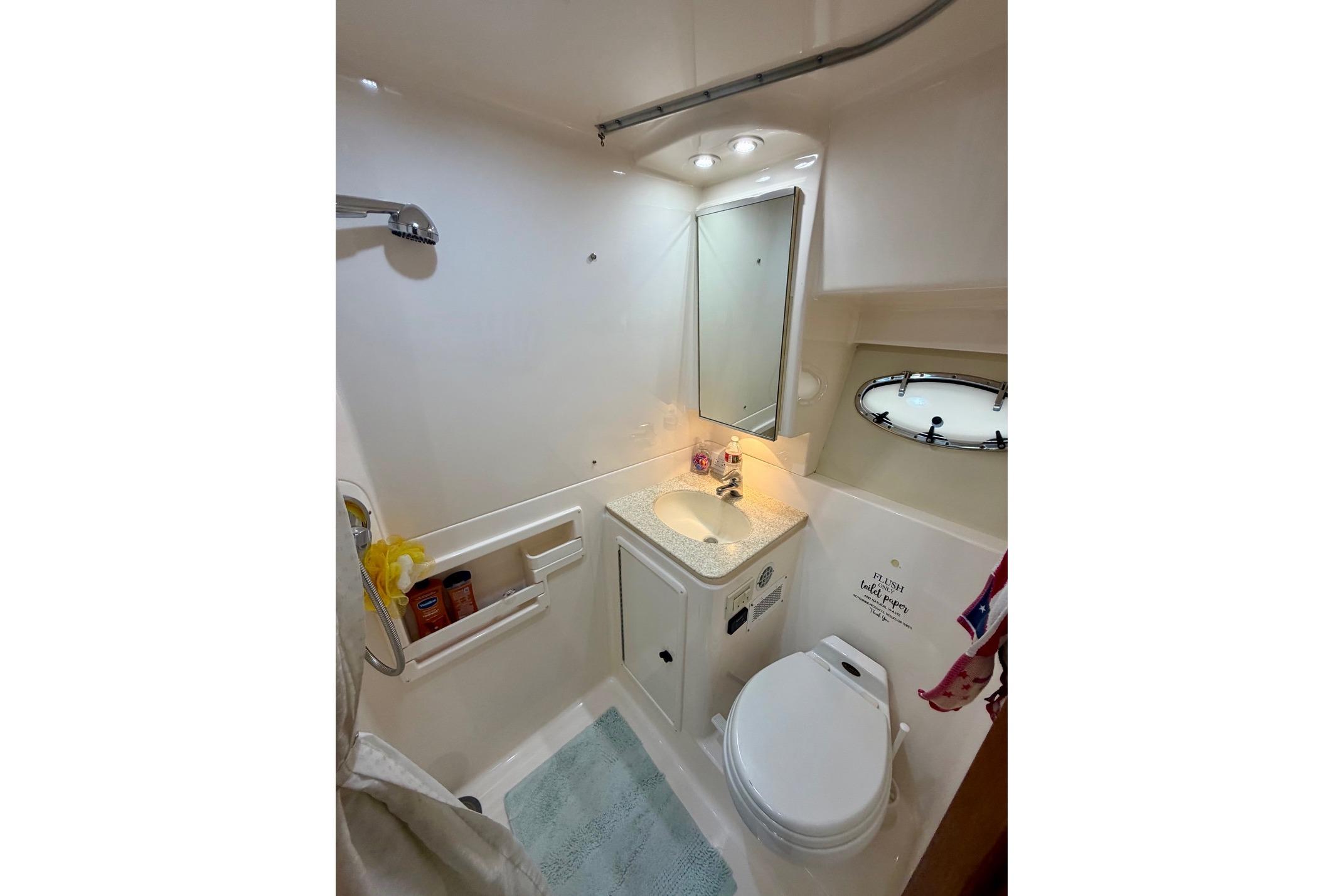2003 Tiara Yachts 3500 Open bathroom with sink, toilet, and shower.