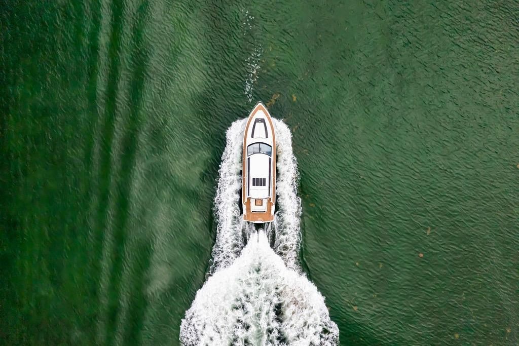Overhead view of 2012 Fairline Targa 58 yacht cruising on green water.