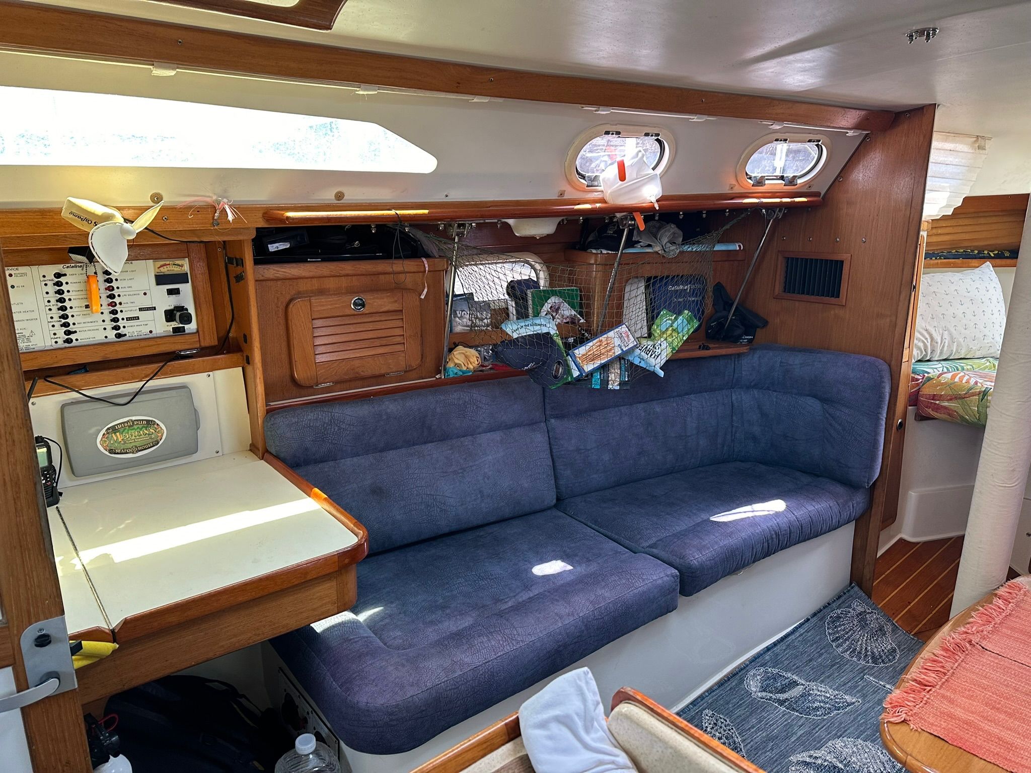 Interior of a 2001 Catalina MkII with a blue couch and wooden paneling.