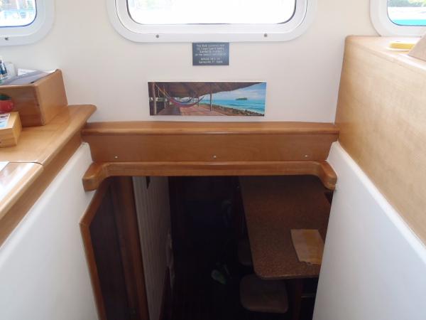Interior view of 2025 Great Harbour N40 yacht, featuring a wooden staircase and dining area.