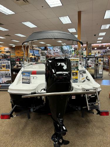 2023 Tahoe T16 boat with Mercury 75 engine displayed indoors.