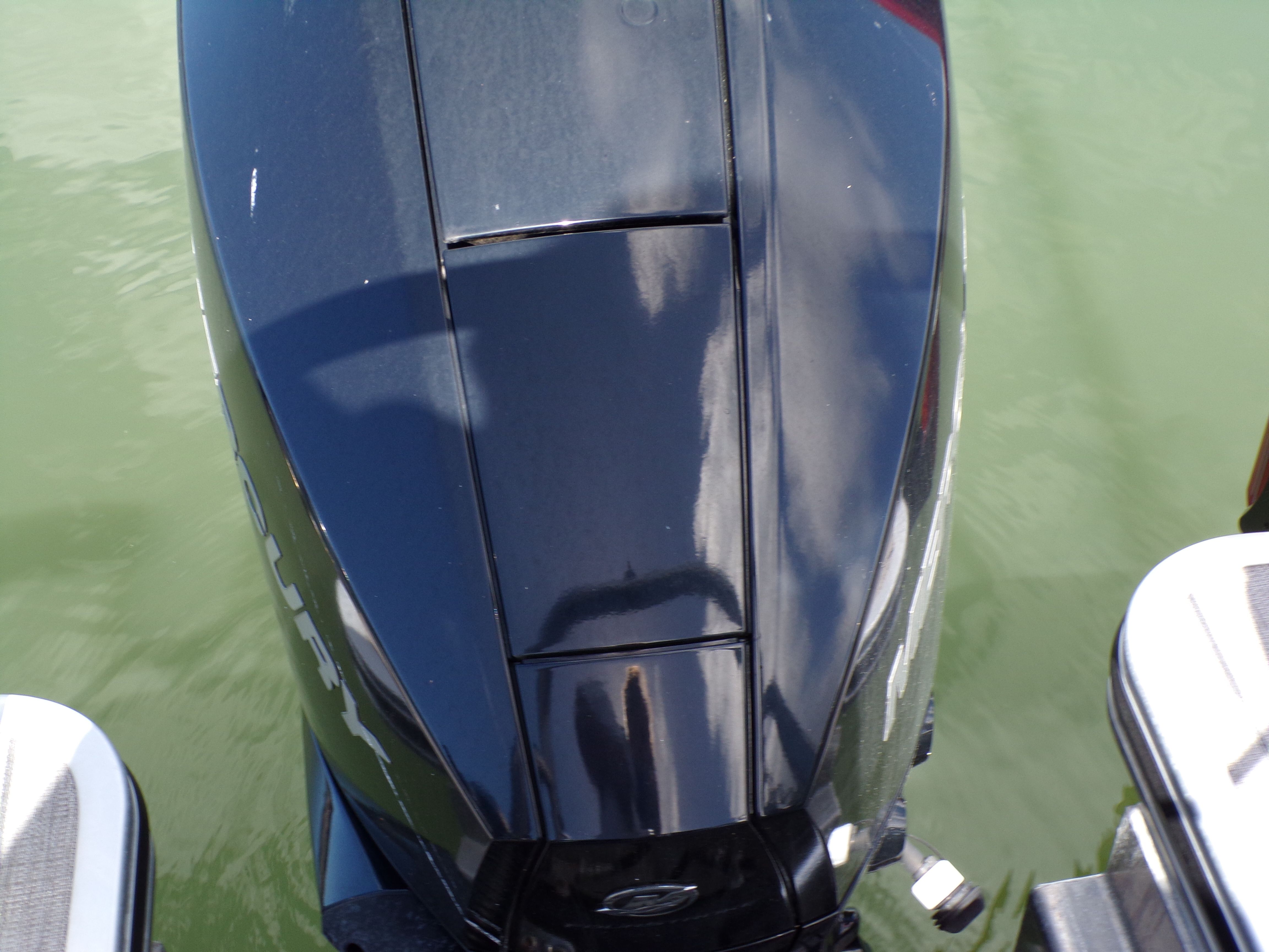 Outboard motor of Harris GRAND MARINER 23, 2022 model, on calm water.