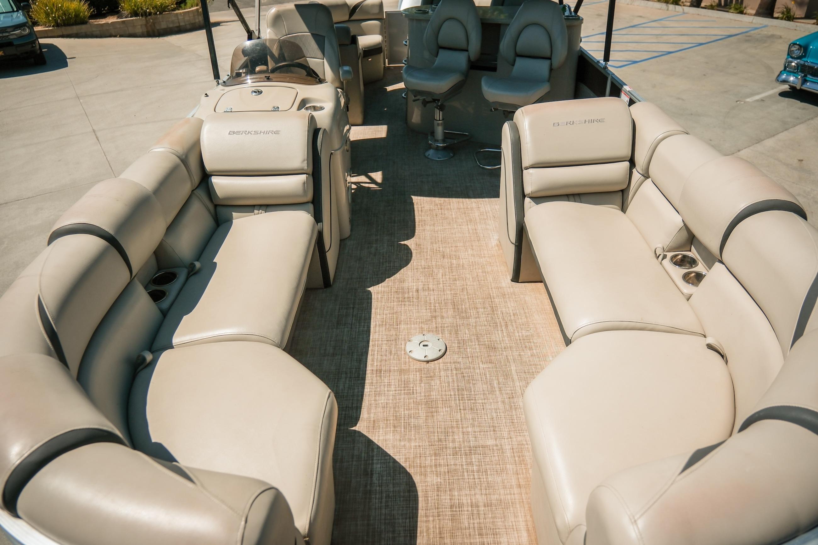2019 Berkshire 25CLE STS pontoon boat with spacious beige seating and modern interior design.