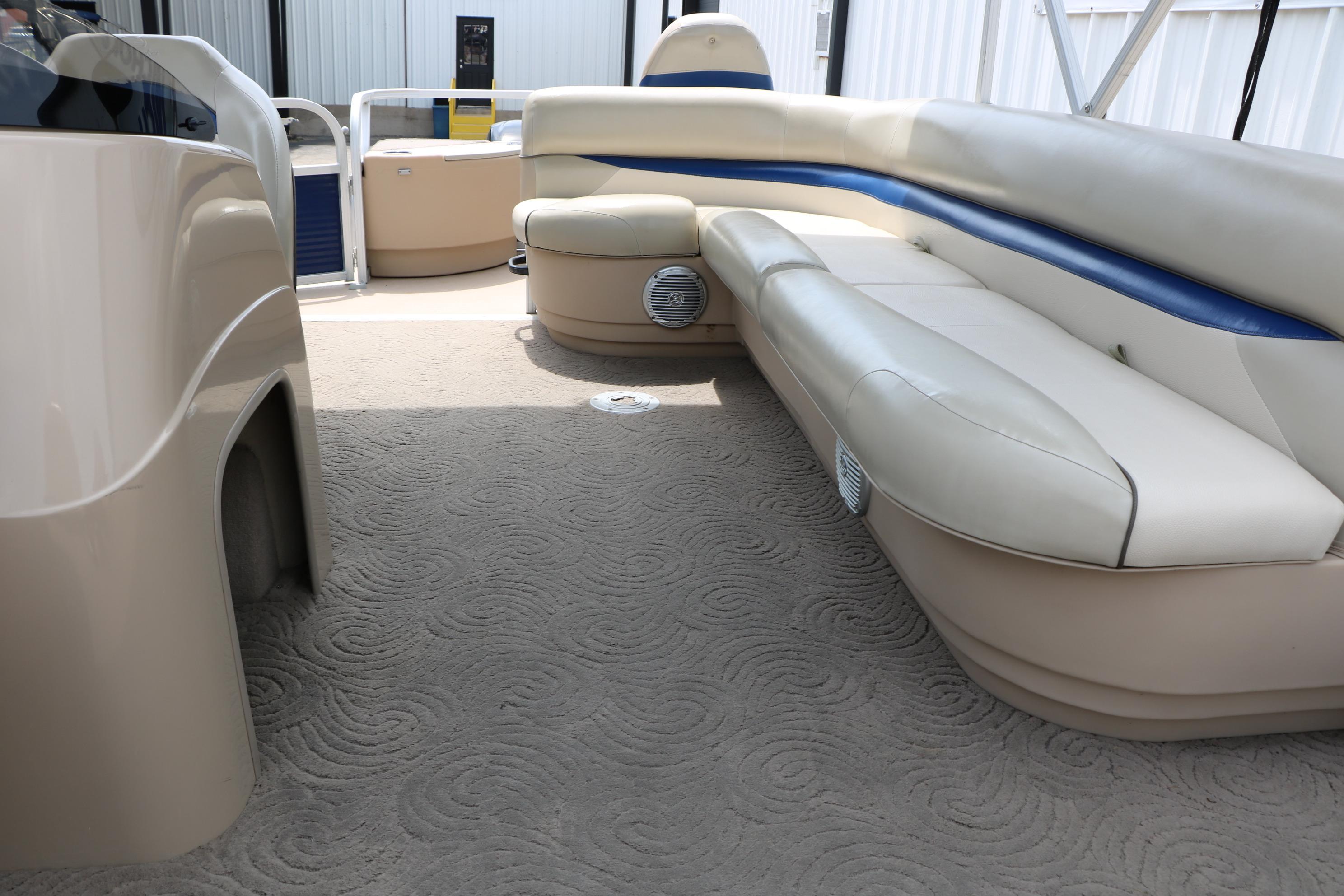 2013 Sun Tracker Fishin' Barge 20 DLX interior with beige seating and carpeted floor.