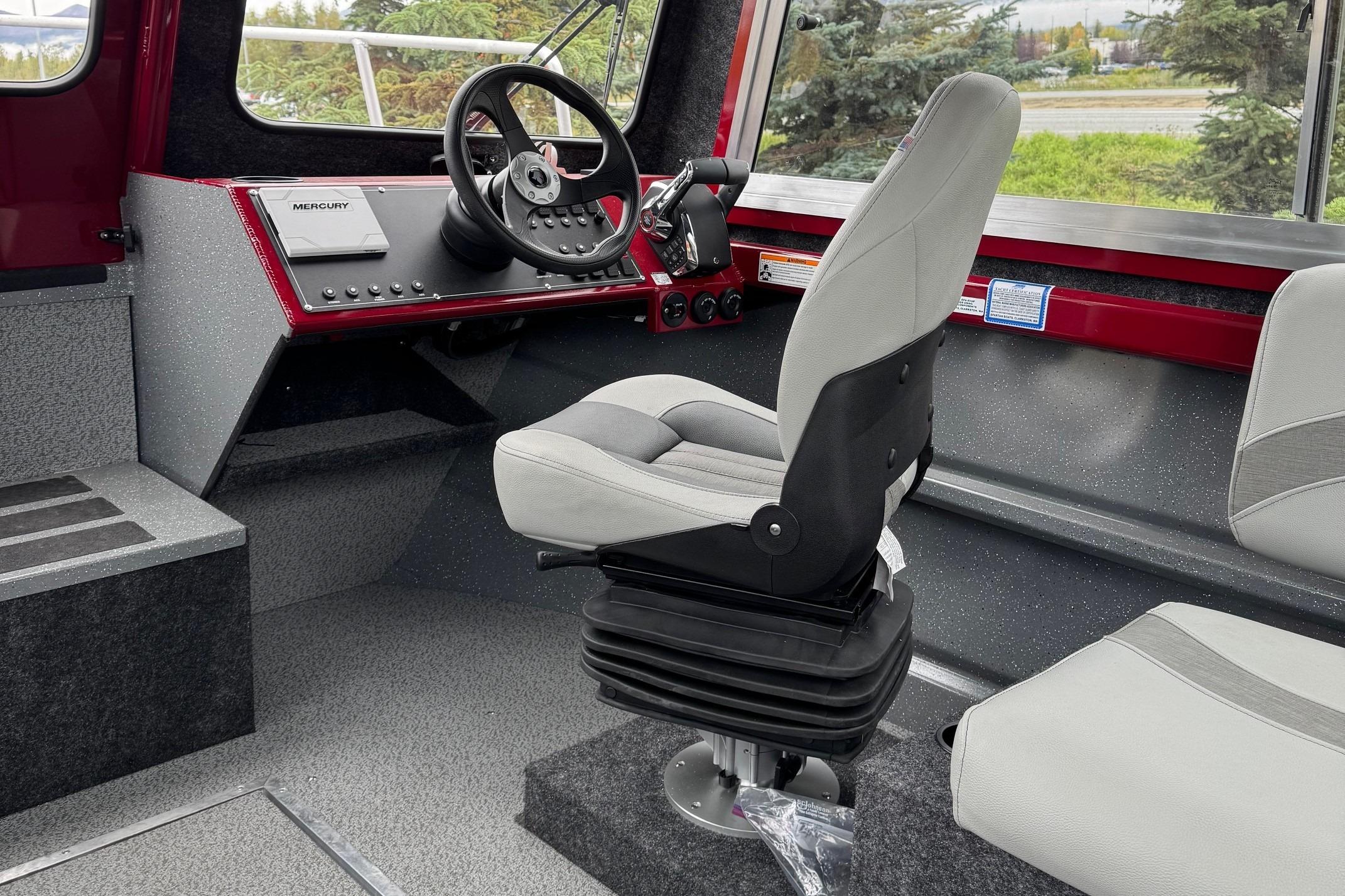 Interior of 2024 Spartan 24 MAXIMUS PRO XL boat with modern steering and seating.