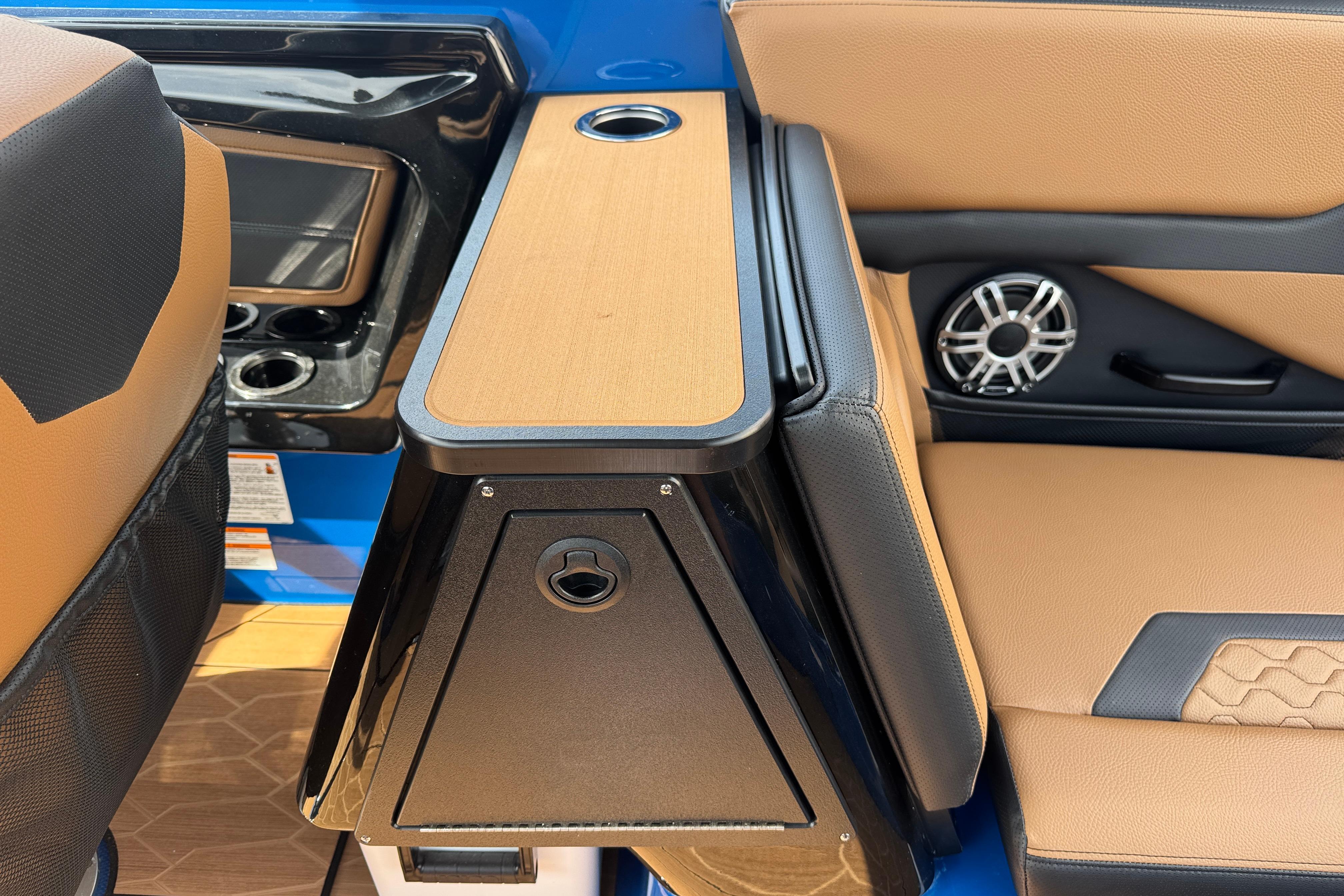 Interior of 2026 Yamaha Boats 255XD, featuring tan and black seating with speaker and cup holder.