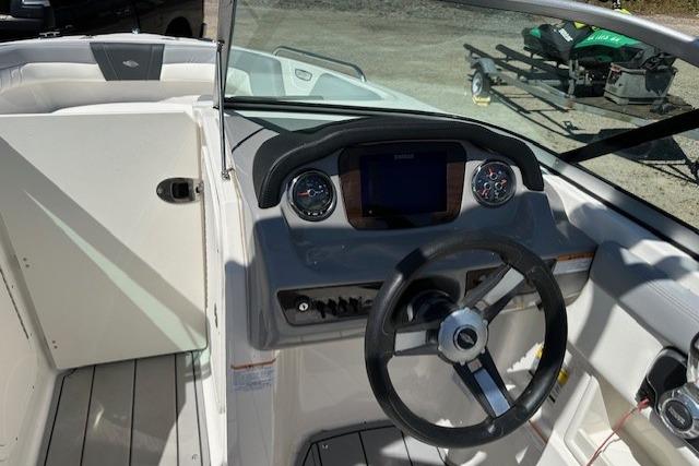 2023 Chaparral 23 SSi boat dashboard with steering wheel and control panel.