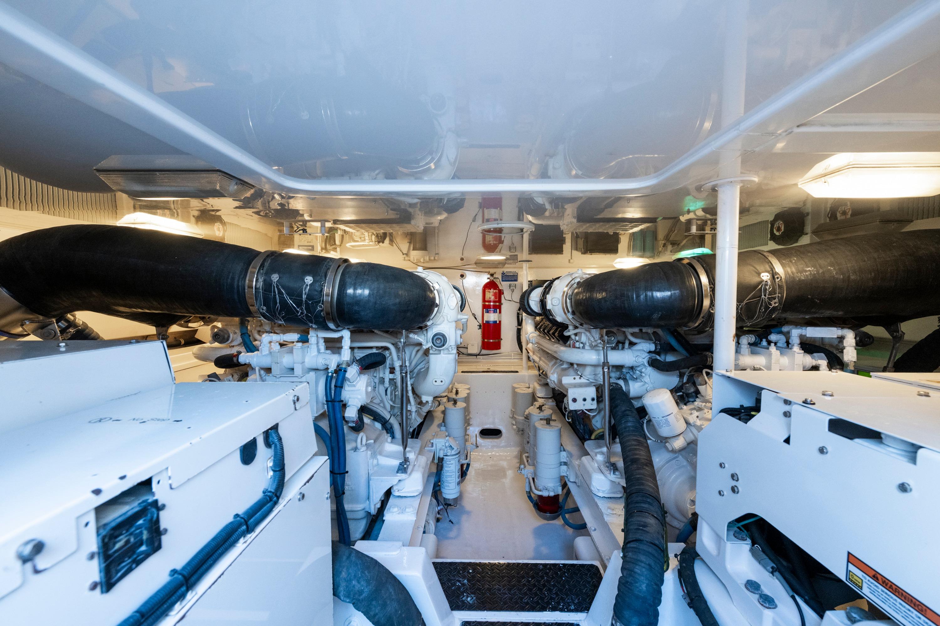 Engine room of 2009 Viking 50 Convertible yacht, featuring dual engines and fire extinguisher.