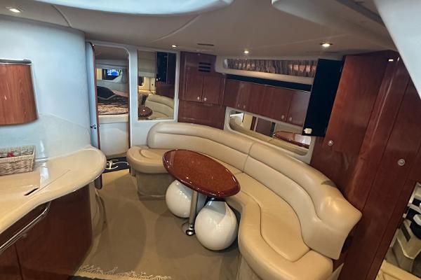 Luxurious interior of 2004 Sea Ray 380 Sundancer yacht with elegant seating and table.