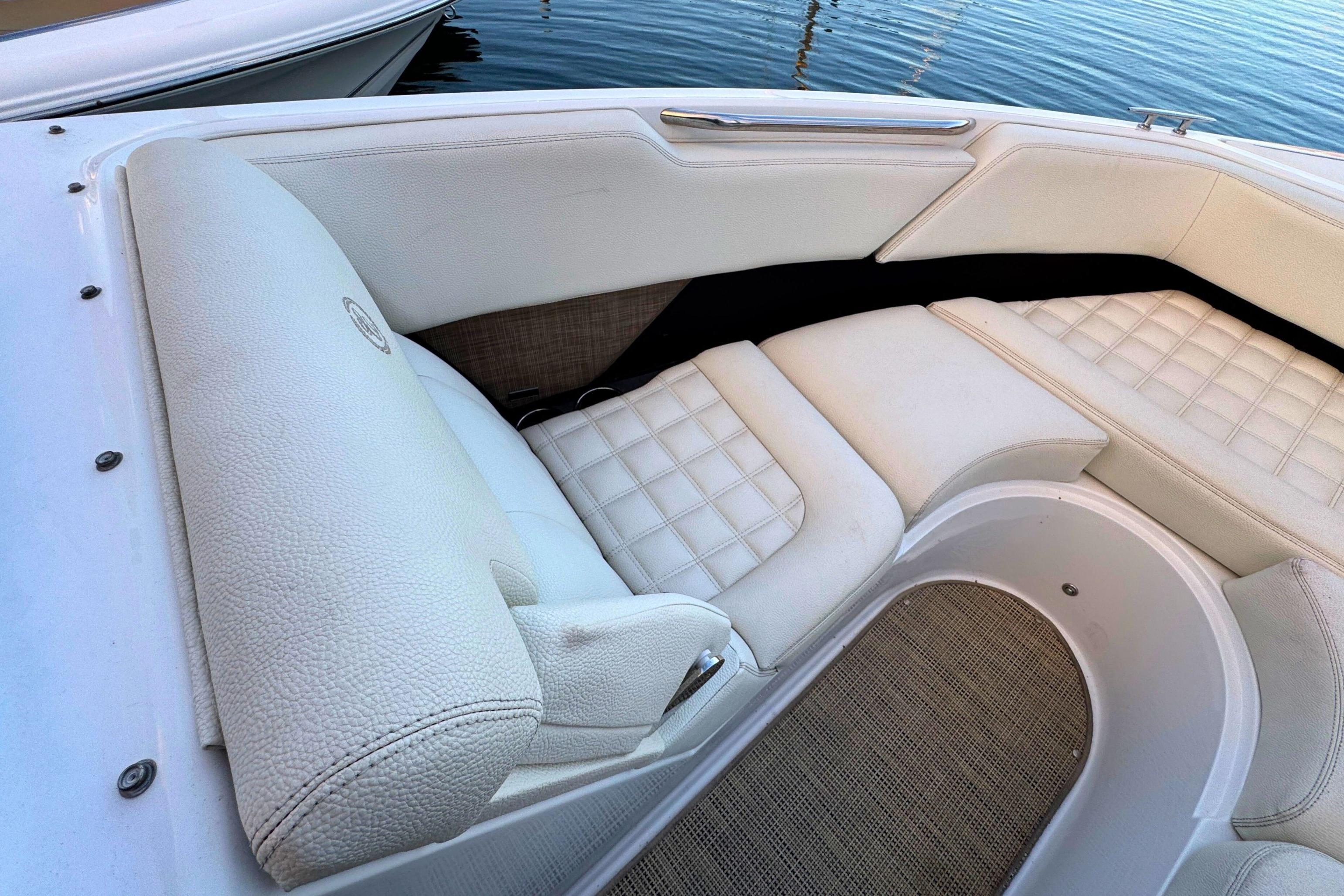 Luxurious white seating on a 2019 Cobalt R3 boat, near water.